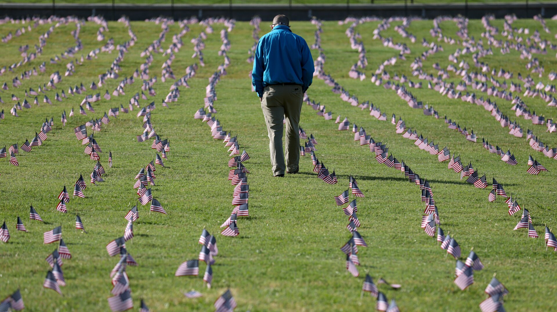 A man walking through a memorial at the National Mall in Washington, DC, created this September to commemorate the 200,000 American lives lost to the pandemic at the time. As many as 500,000 Americans may die before the pandemic ends, some experts have estimated.