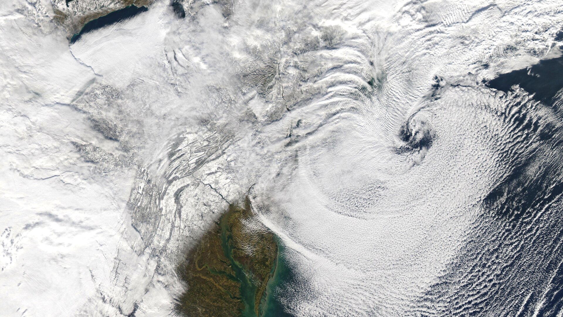 The swirling tail of the nor’easter moves further offshore, revealing the snow-blanketed Northeast on Dec. 17.