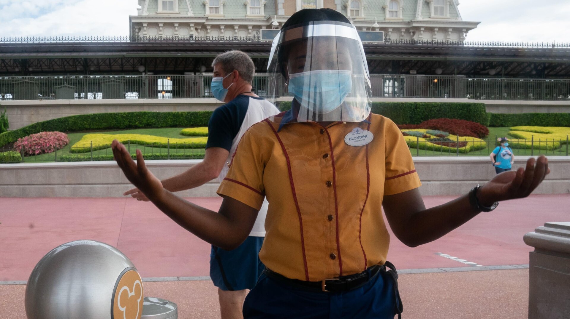 An employee at Walt Disney World Resort’s Magic Kingdom wears a facemask and face shield at the entrance to the park during the COVID-19 pandemic in Orlando on July 23, 2020.