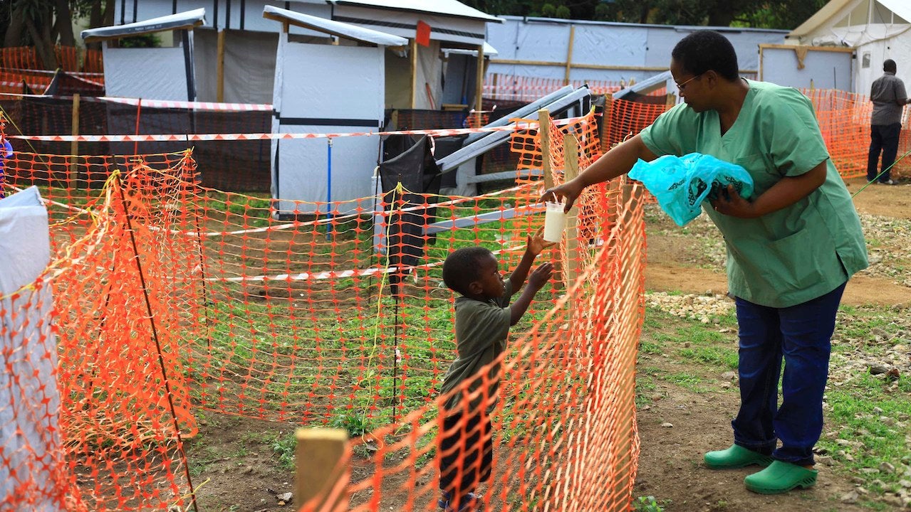 A health worker feeds a boy suspected of having the Ebola virus at an Ebola treatment center in Beni, Eastern Congo.