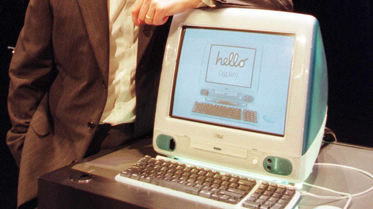 Steve Jobs shows off an iMac in 1998.