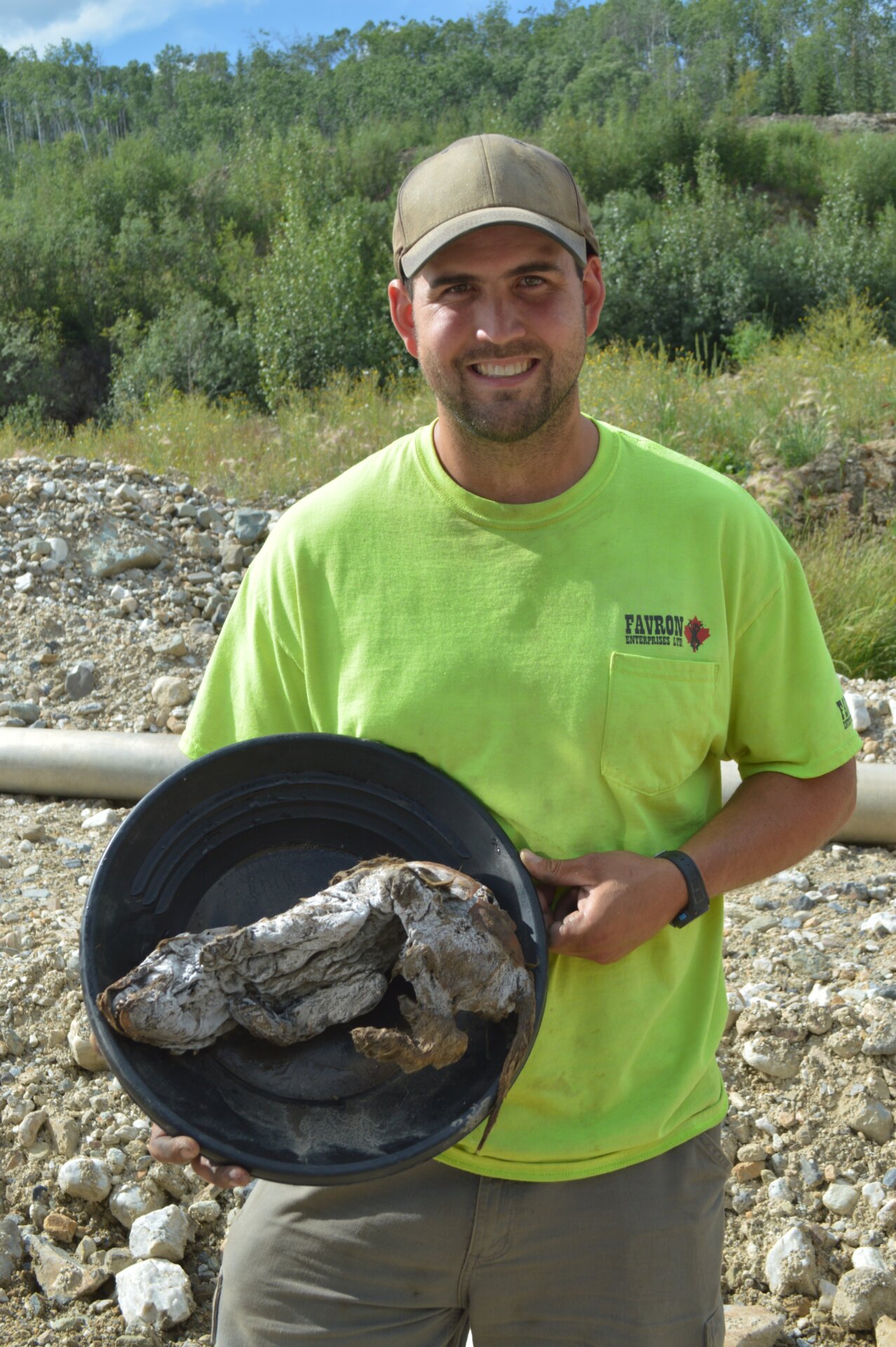Gold miner Neil Loveless with the wolf pup he found. 