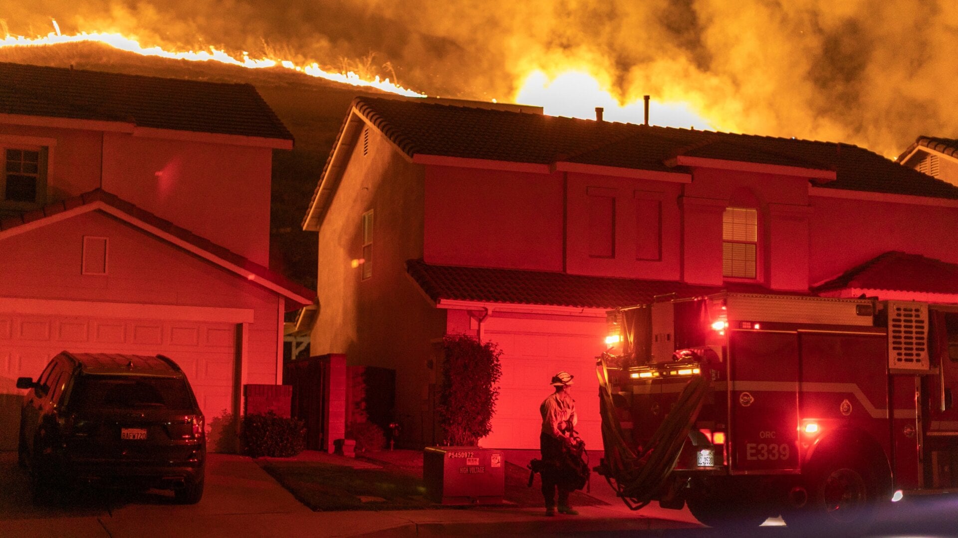 Flames come close to houses during the Blue Ridge Fire on Oct. 27, 2020 in Chino Hills, California.