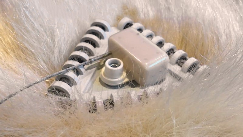 One prototype uses off-the-shelf bottle brushes, entangling a polar bear’s fur in its plastic bristles.