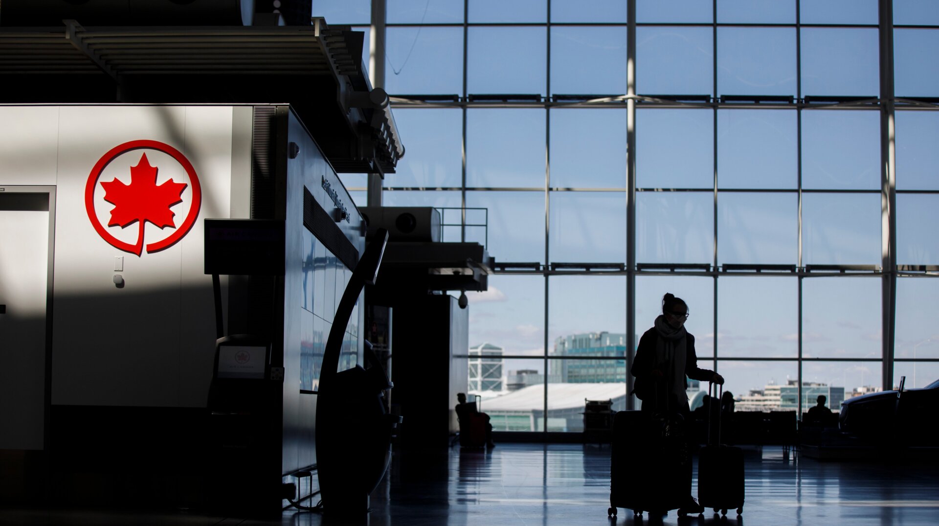 A passenger wheeling her luggage at the Toronto Pearson International Airport on April 1, 2020 in Toronto, Canada