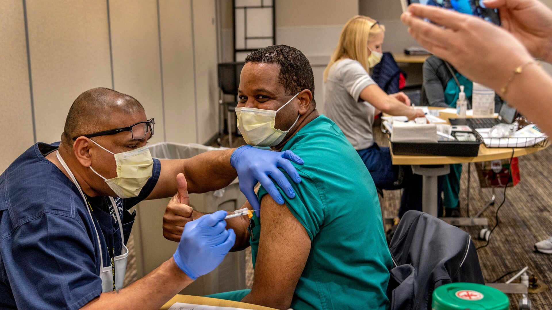 Nurse practitioner Robert McCary receives the Pfizer-BioNTech covia-19 vaccine at Sutter Medical Center in Sacramento, California on Dec. 18, 2020.