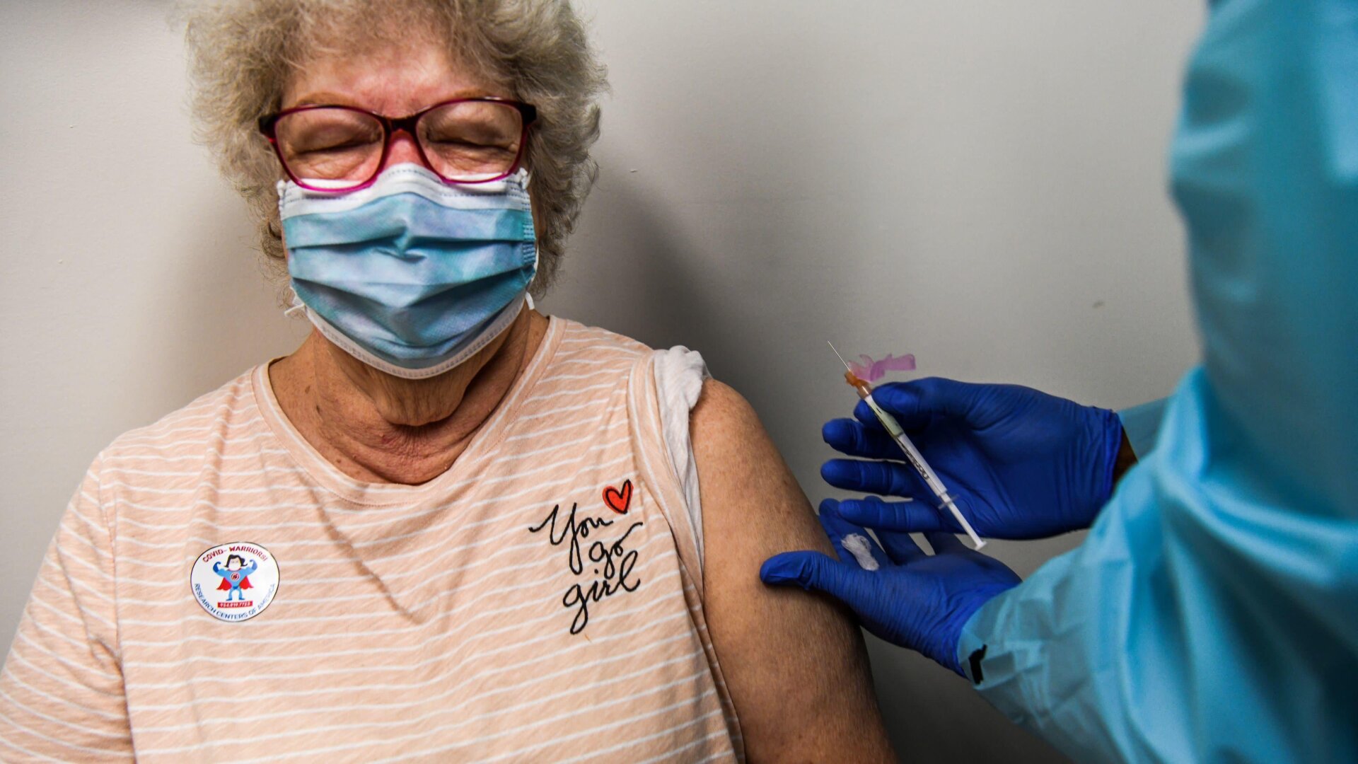 Healthcare worker Daisie Esseie receives a Pfizer/BioNtech covid-19 vaccine from nurse practitioner Hari Leon Joseph at the Research Centers of America in Hollywood, Florida on December 18, 2020.