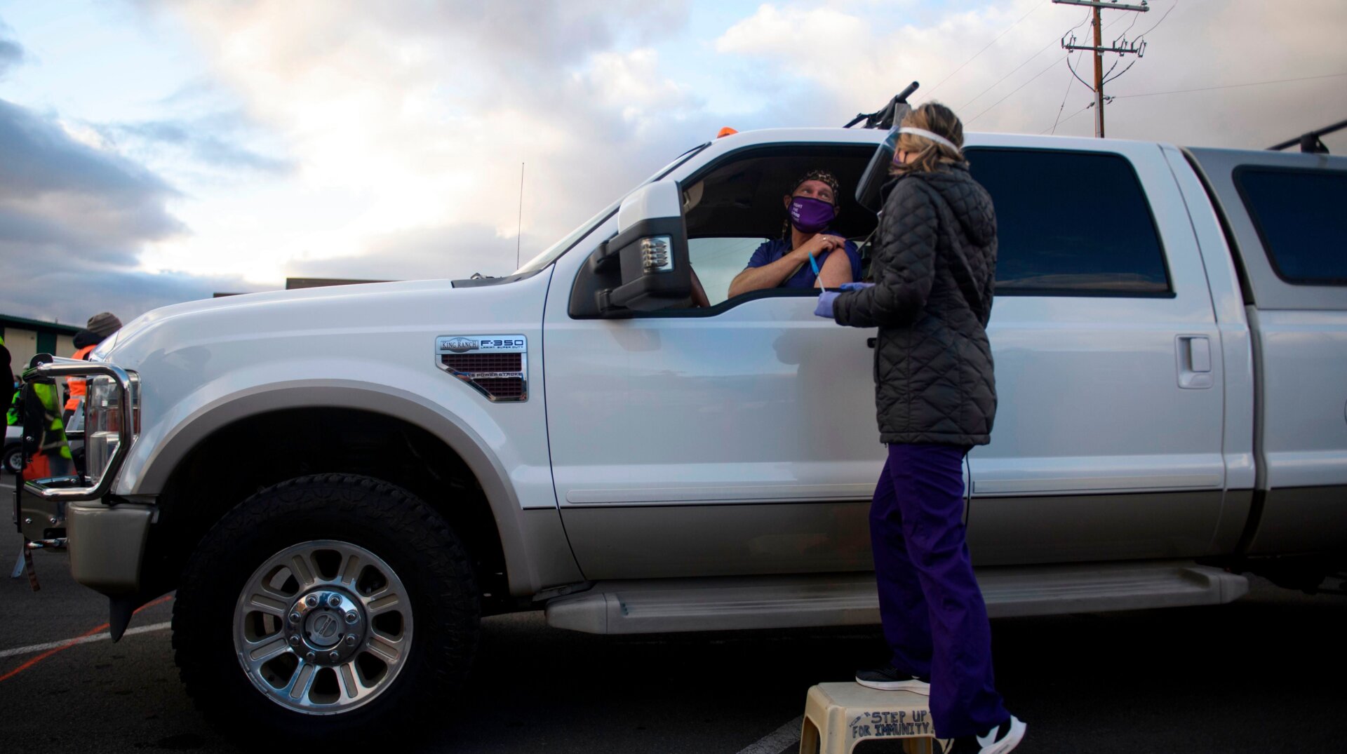 Dr. Bret Frey, an emergency medicine physician, talks with a nurse from inside a truck after receiving a first dose of the Pfizer/BioNTech covid-19 vaccine under an emergency use authorization at a drive-up vaccination site from Renown Health on December 17, 2020 in Reno, Nevada.