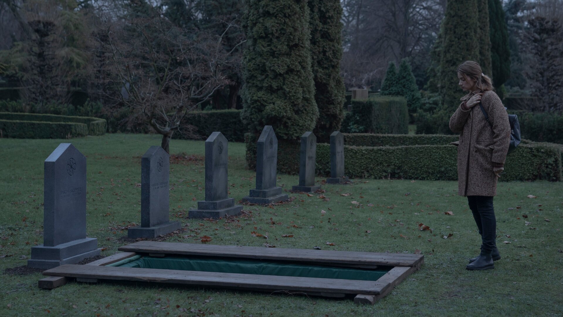 Astrid (Danica Curcic) looks upon a peculiar grave.