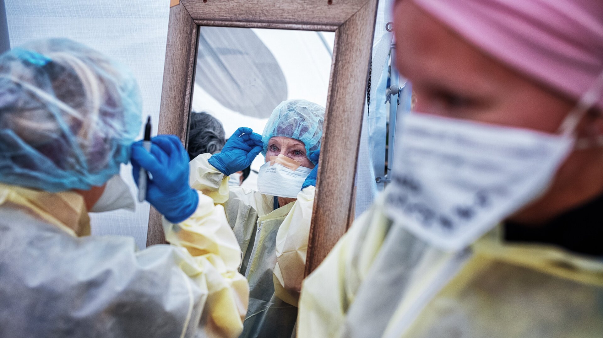Medical workers putting on protective equipment at the beginning of their shift at the emergency field hospital run by Samaritan’s Purse and Mount Sinai Health System in Central Park on April 21, 2020 in New York City.