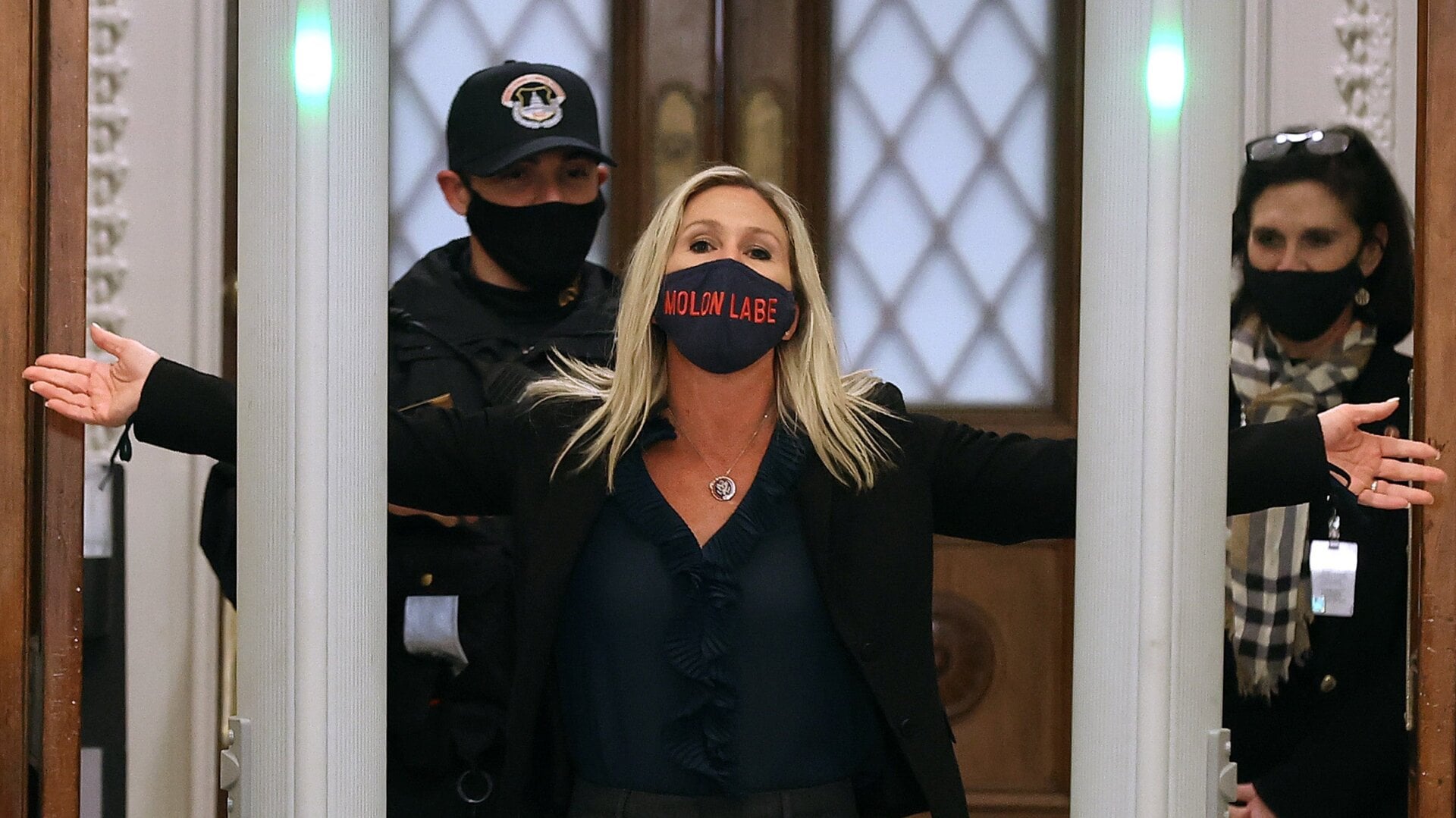 Rep. Marjorie Taylor Greene is searched by Capitol Police after setting off the metal detector outside the doors to the House of Representatives on Jan. 12, 2021.