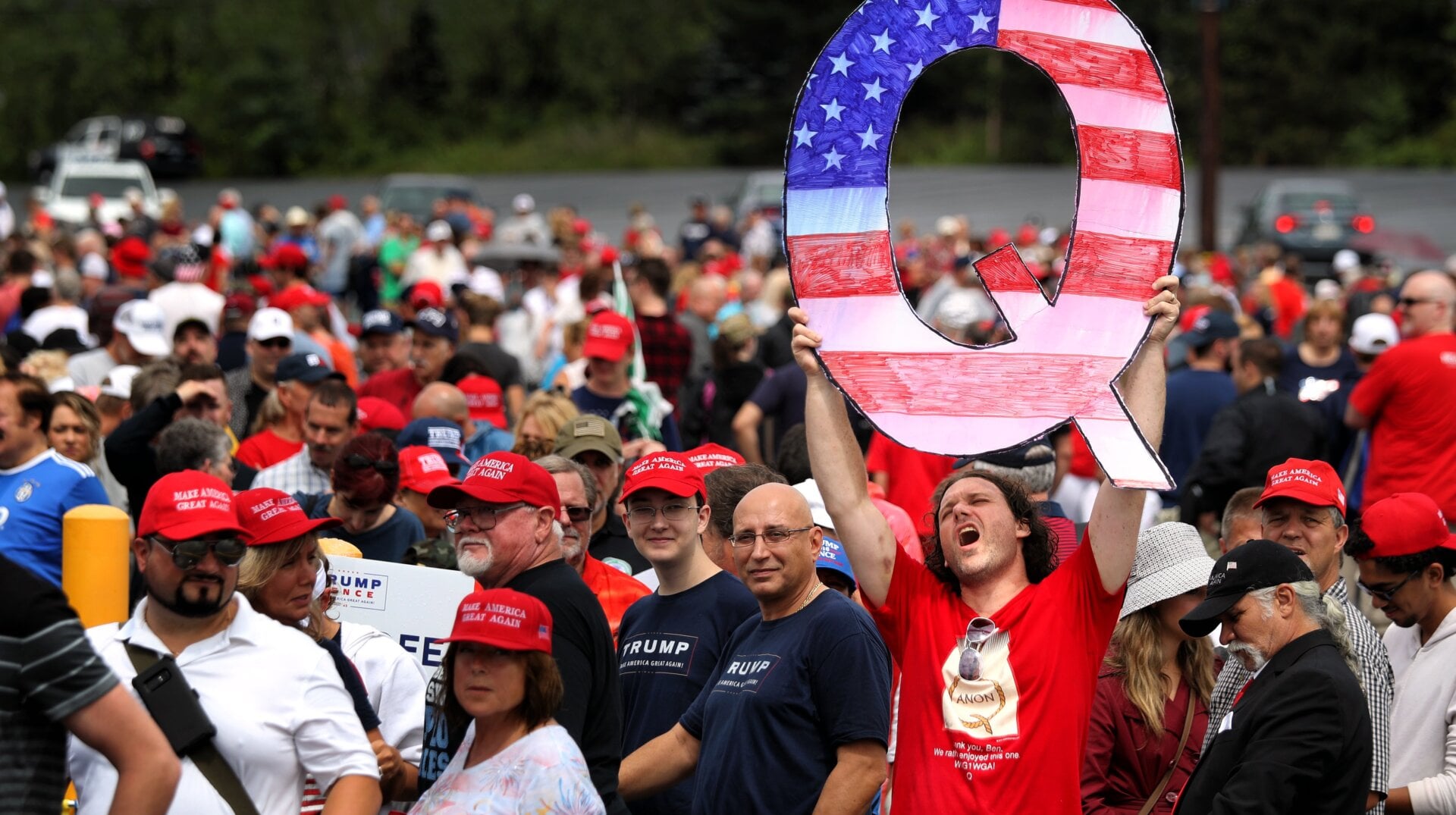David Reinert holds up a large “Q” sign while waiting in line to see President Donald J. Trump at his rally on August 2, 2018 at the Mohegan Sun Arena at Casey Plaza in Wilkes Barre, Pennsylvania.