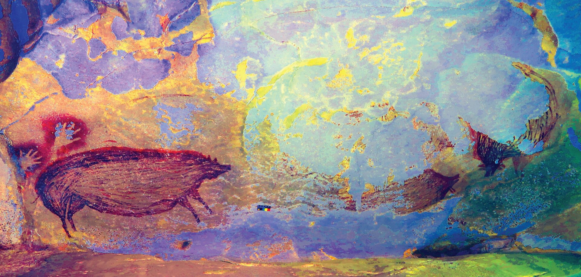 The entire cave painting at Leang Tedongnge, with two partial warty pigs at right, and a pair of hand stencils at left. 