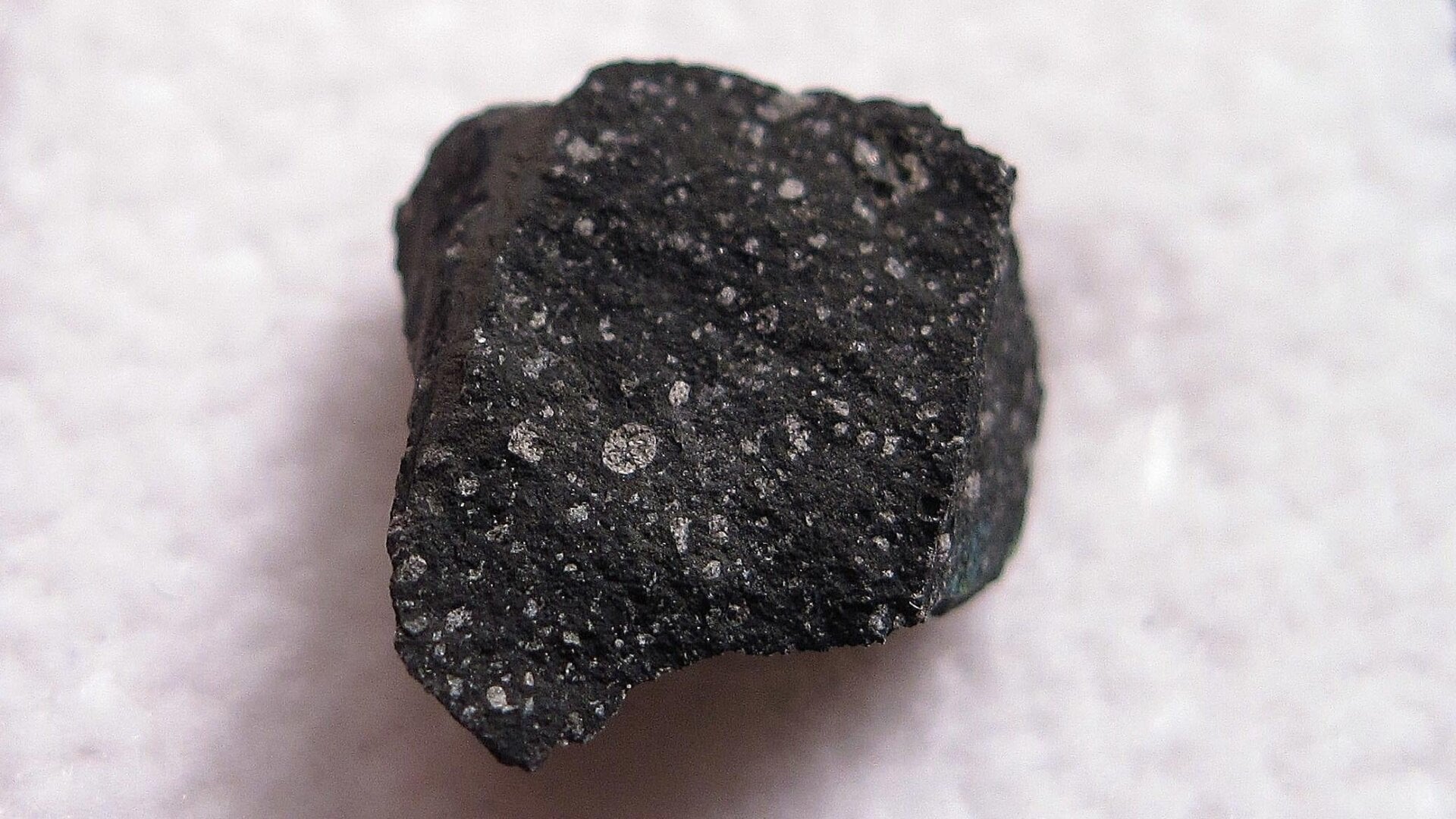 A fragment of the Murchison meteorite, a carbonaceous chondrite fall from Australia.