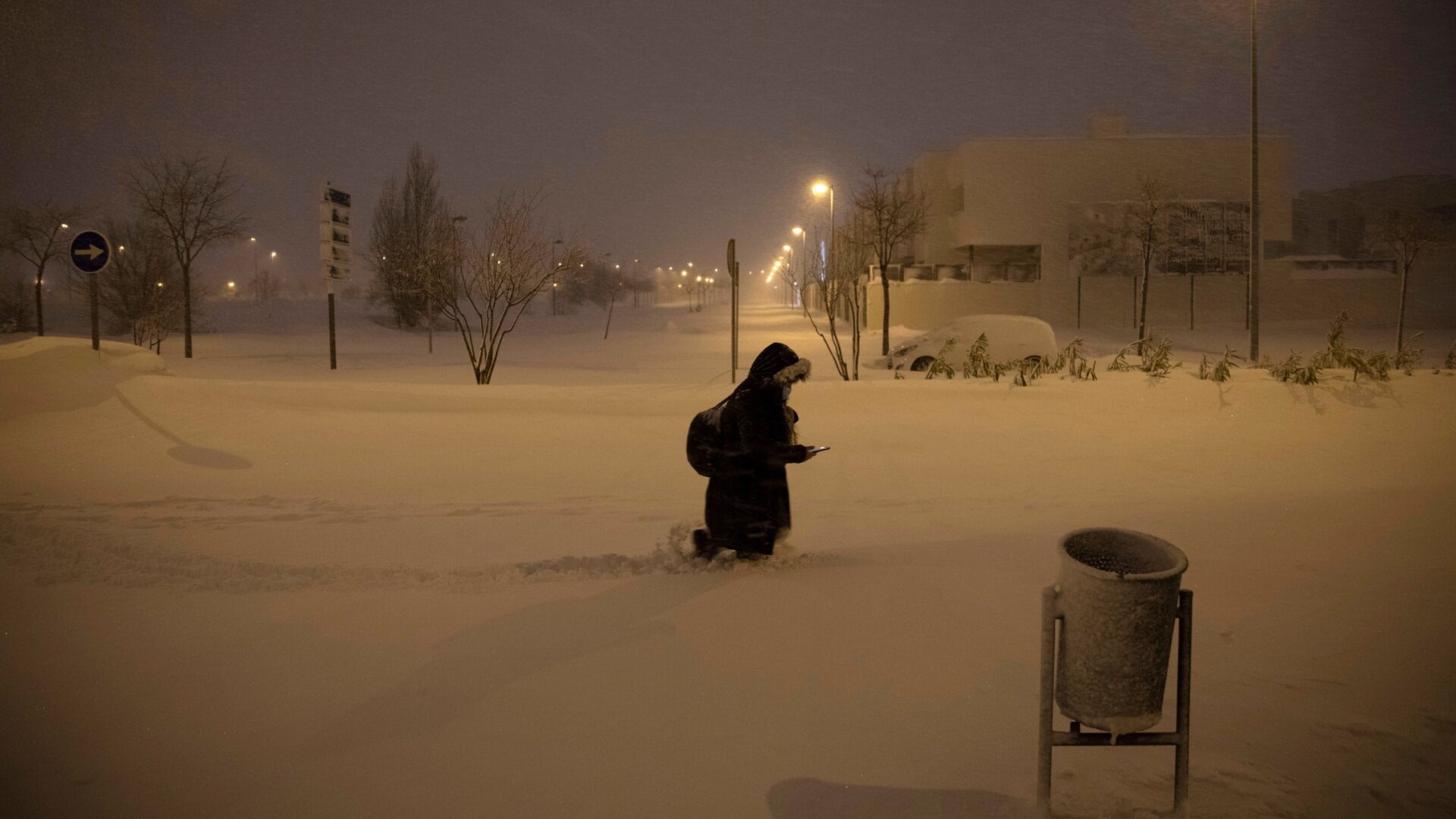 A woman walks along a street covered with snow during heavy snowfall on January 09, 2021 in Alcorcón, near Madrid, Spain.