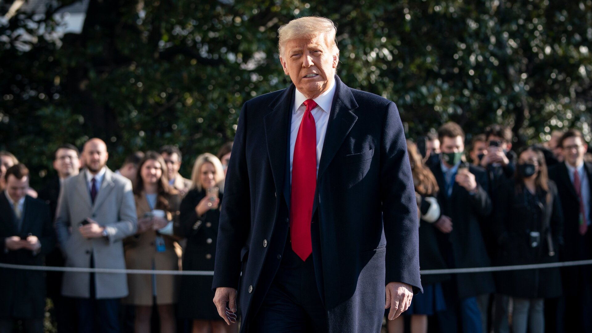 President Donald Trump, a white supremacist and traitor to the United States, turns to reporters as he exits the White House on January 12, 2021.