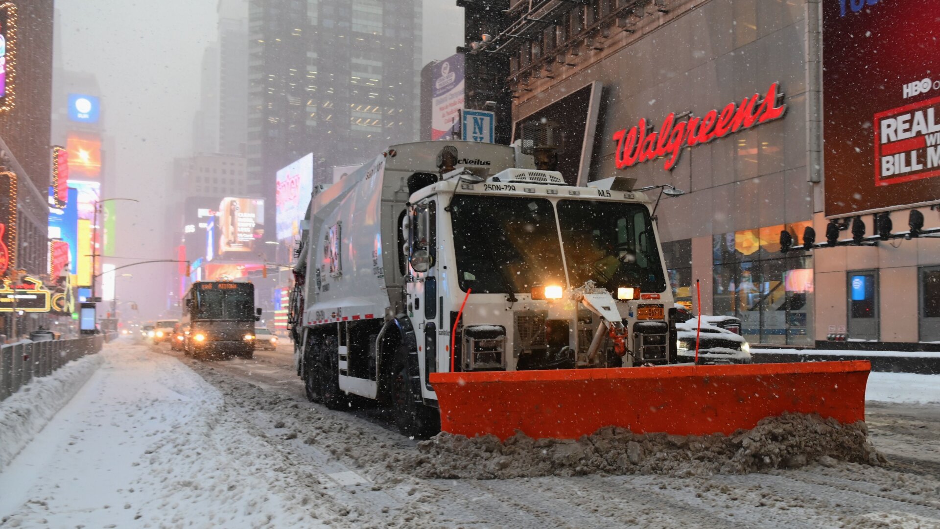 Snowplows drive through Times Square during a winter storm on Feb. 1, 2021.