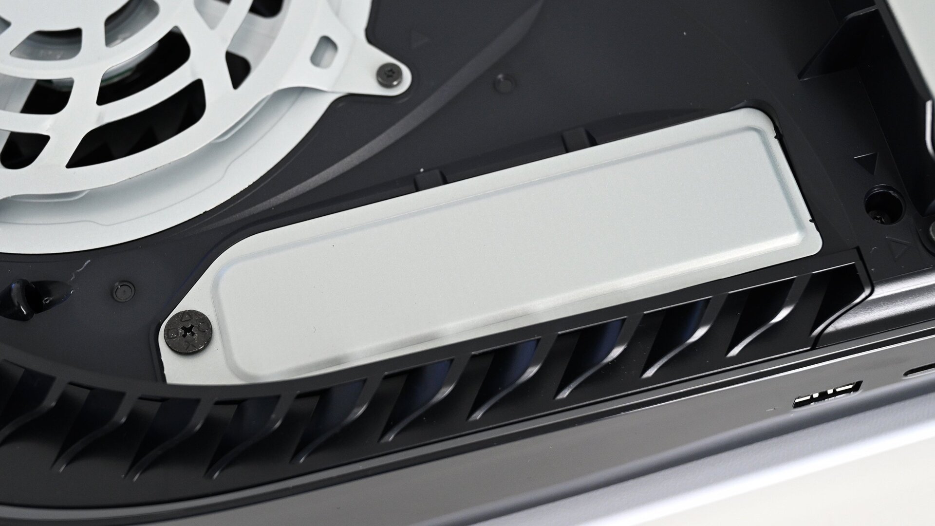 The PS5's M.2 SSD expansion slot is located beneath this cover on the side of the console. 