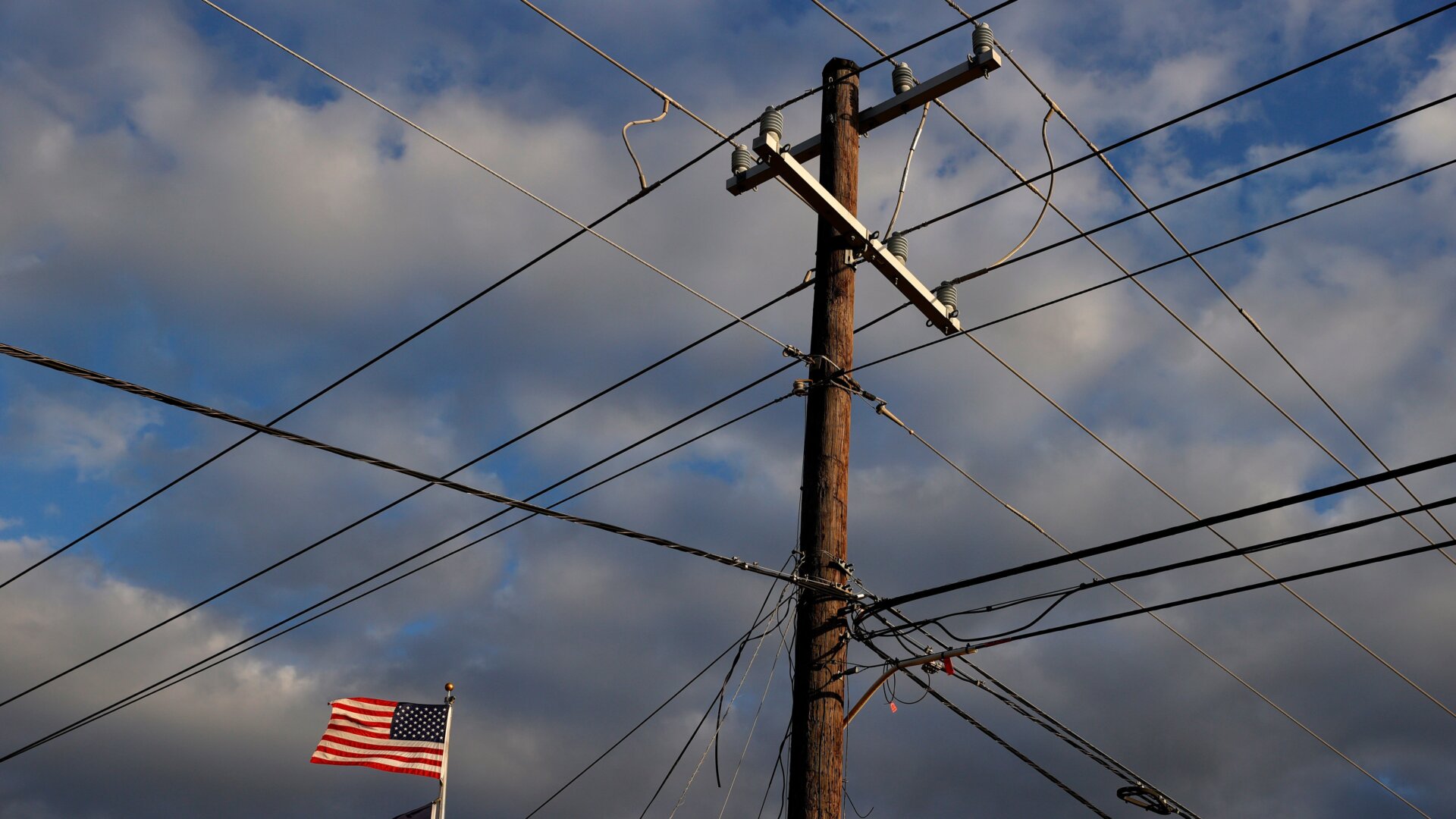 The U.S. flag flies next to a power pole on Feb. 21, 2021 in Houston, Texas.