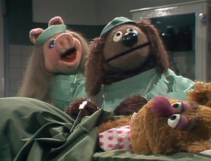 Piggy and Rowlf operating on Fozzie.