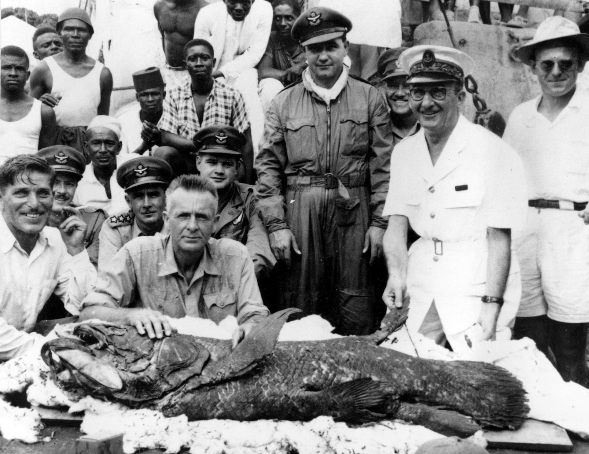 Scientists and sailors pose with a 120-pound coelacanth caught off the coast of Madagascar in 1953.