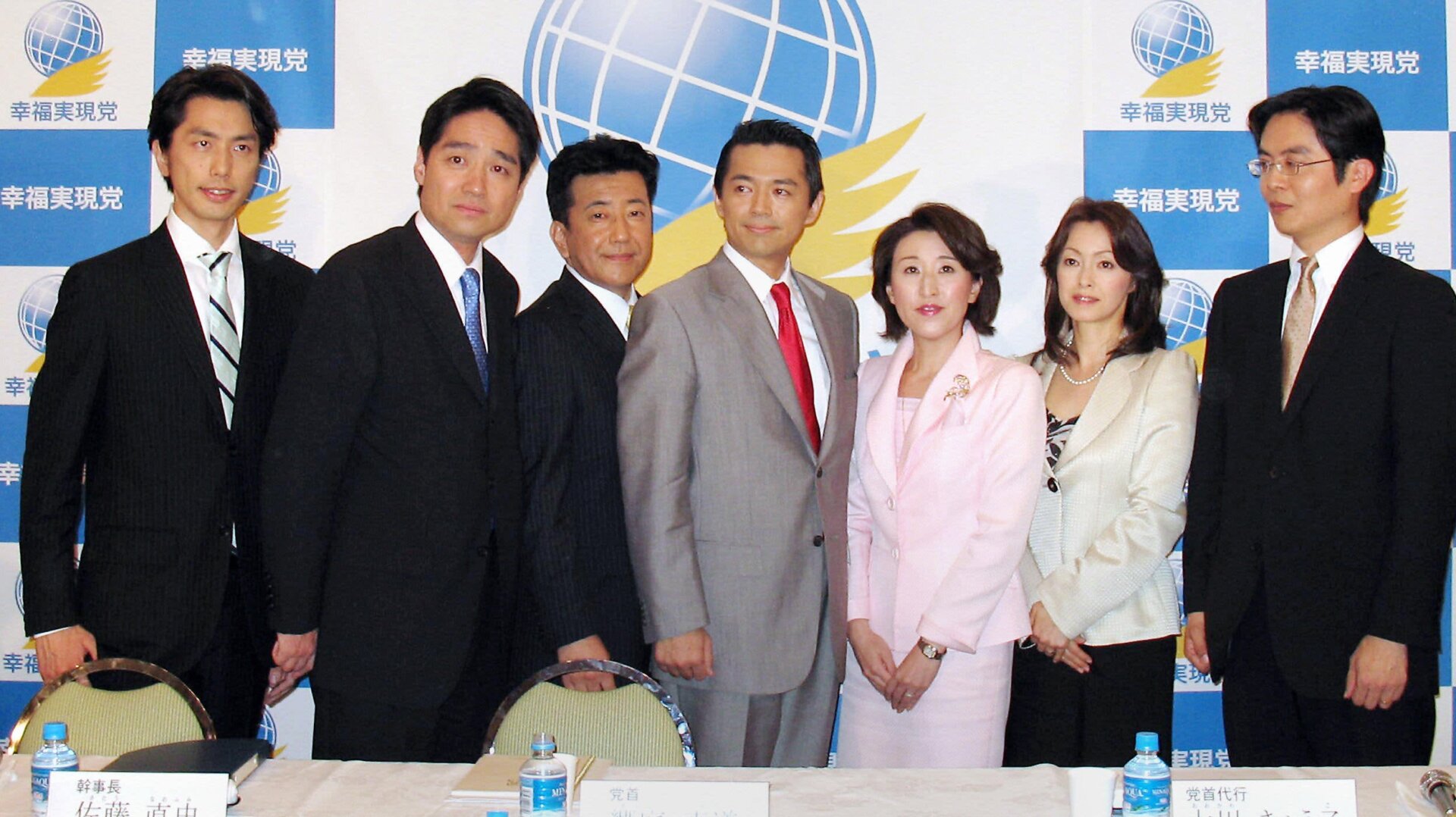 Happiness Realization Party candidates, including Jay Aeba (seen in the gray suit at center), at a Tokyo hotel in 2009.