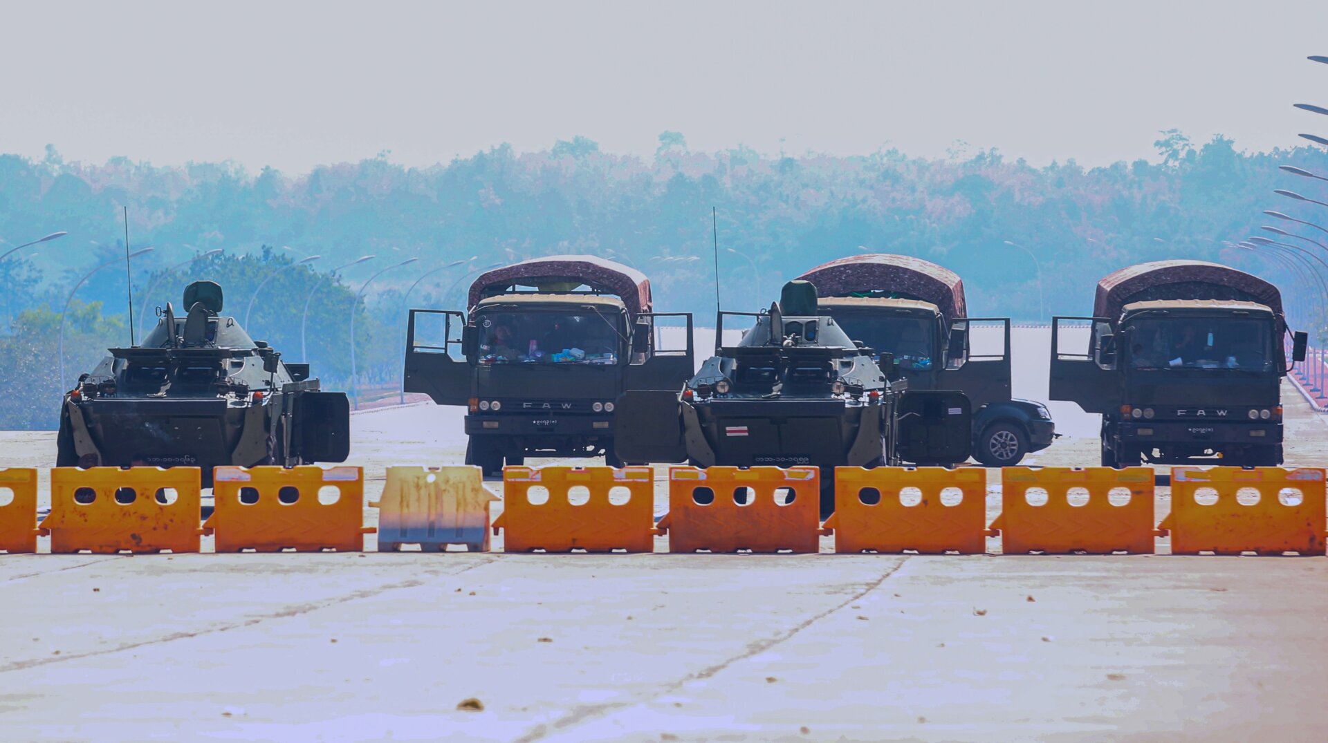Military vehicles take position on a blockaded road near Myanmar’s Parliament in Naypyidaw on February 4, 2021.