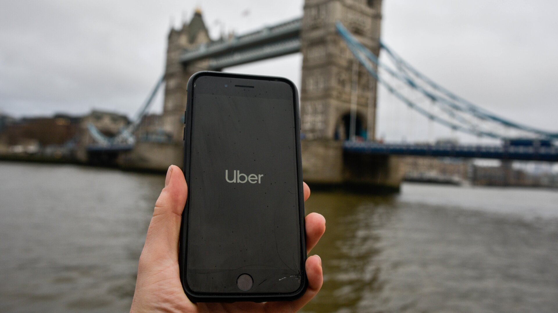 File photo illustration showing the Uber logo on a phone in front of Tower Bridge in London, England.