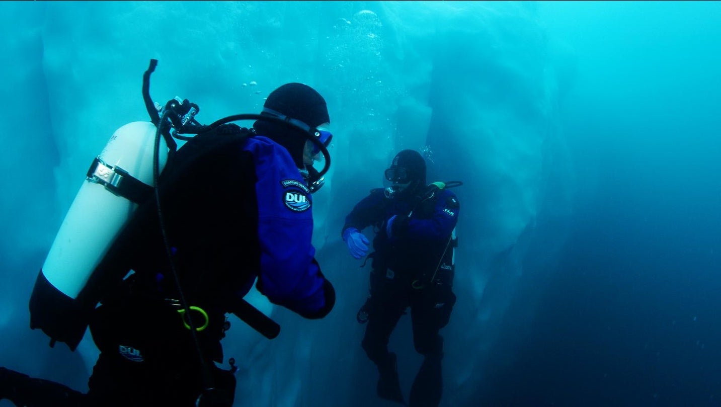 The authors collecting specimens on iceberg shown in the image above.