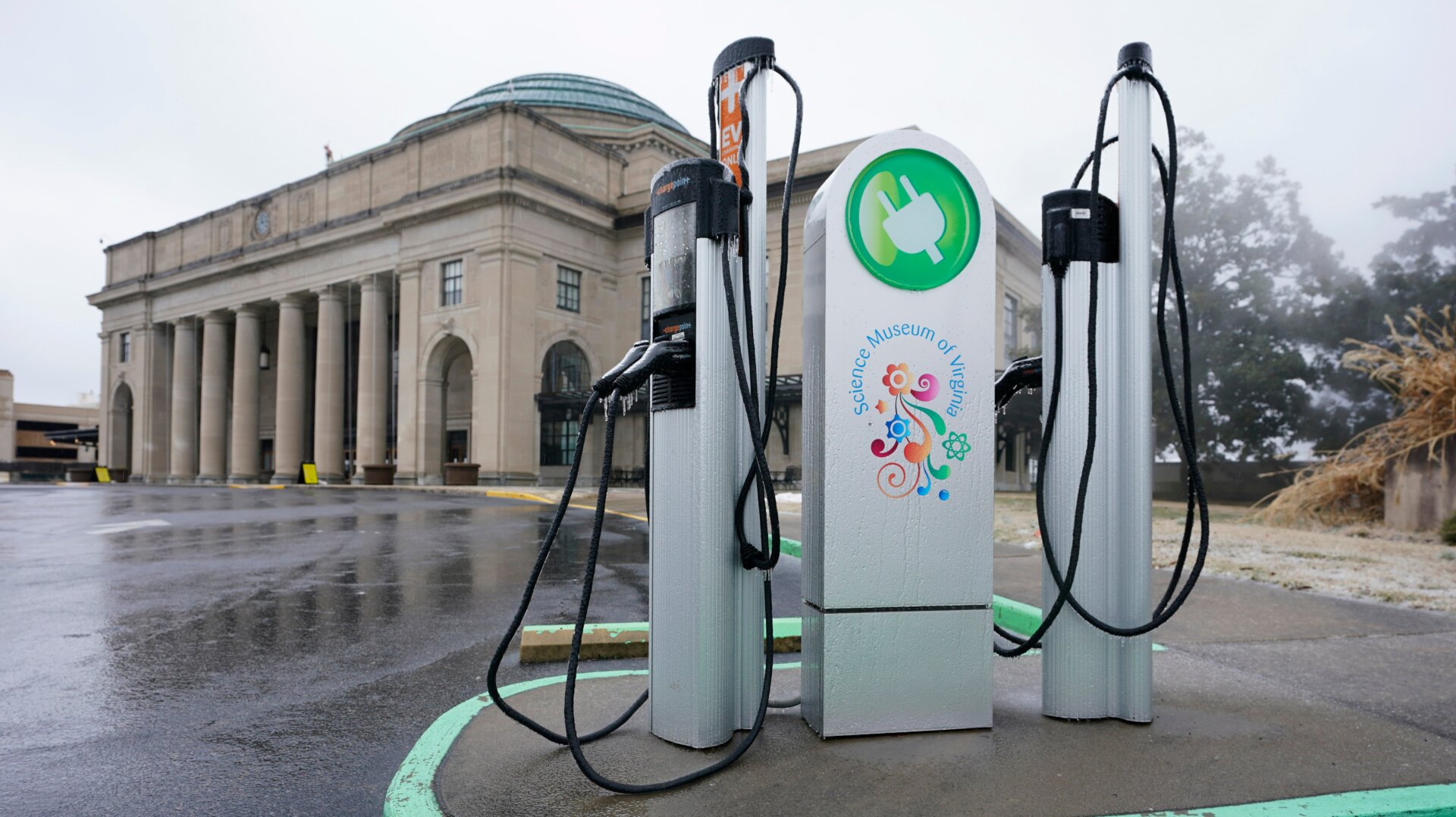 An electric car charging station is positioned outside the Science Museum in Richmond, VA.