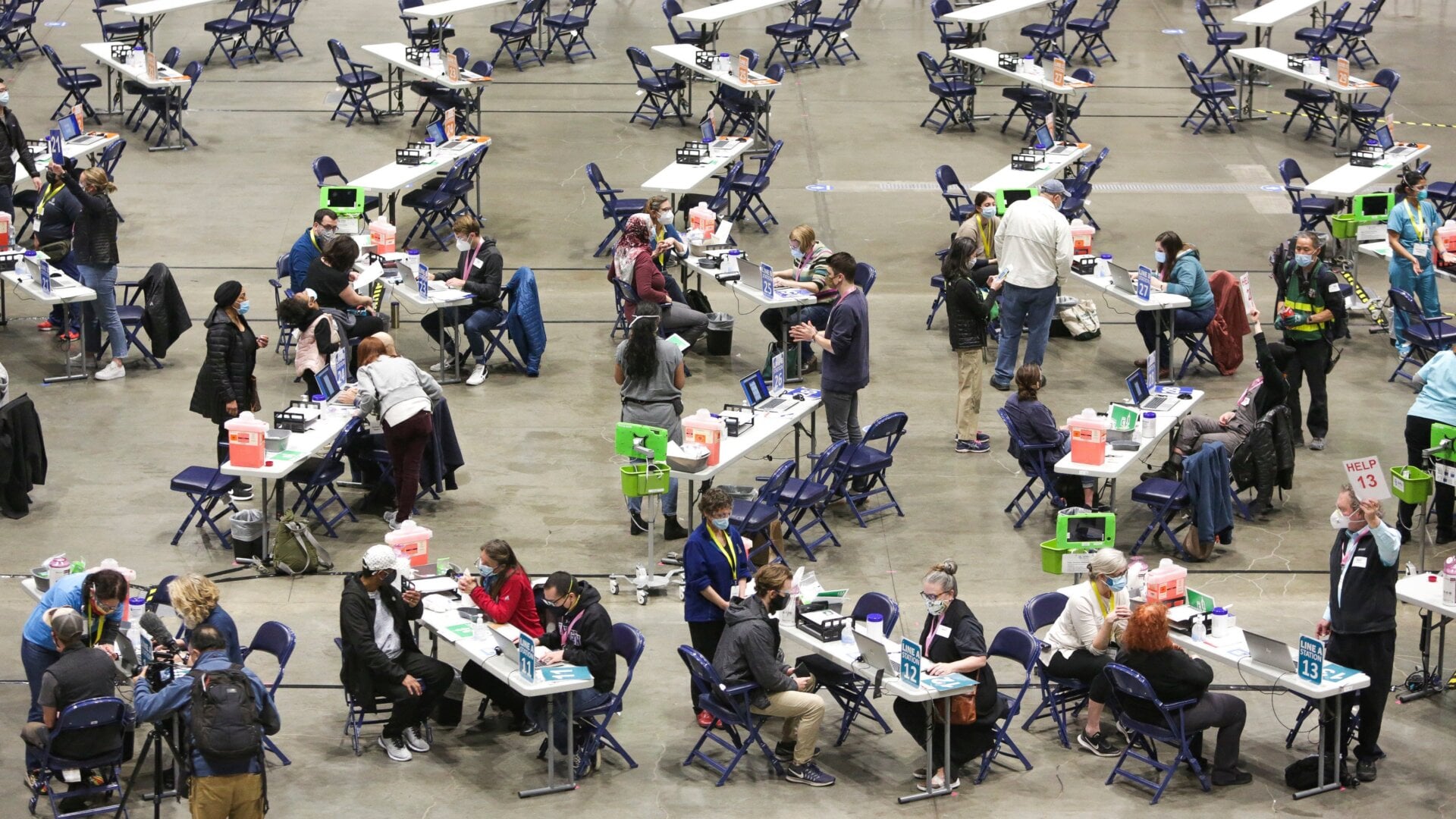 People receive the Pfizer covid-19 vaccine during opening day of the Community Vaccination Site, a collaboration between the City of Seattle, First & Goal Inc., and Swedish Health Services at the Lumen Field Event Center in Seattle, Washington on March 13, 2021.