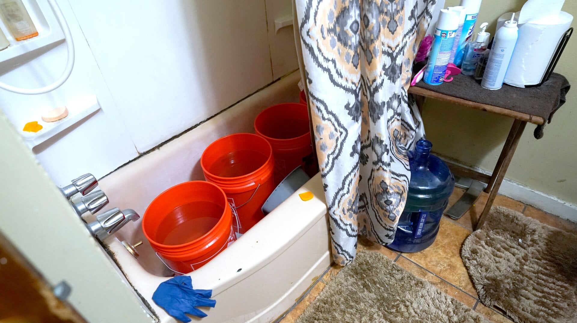 In this Feb. 22, 2021 photo, Doris Devine in Jackson, Mississippi, stores containers with potable water provided by Jackson councilman and state Rep. De’Keither Stamps in her tub. With no water pressure, the water will be used to flush the toilet.