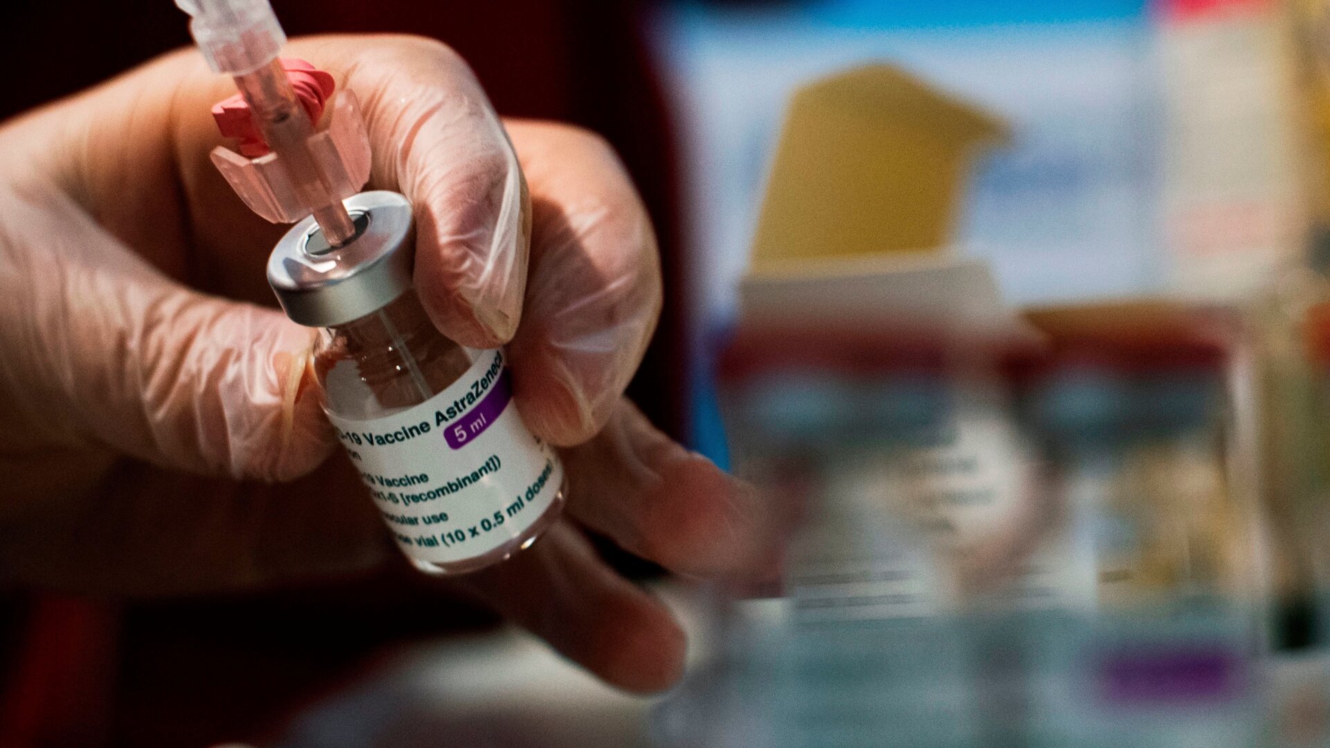 A Red Cross volunteer handles a dose of the AstraZeneca vaccine in a vaccination site set up at Rome’s Fiumicino airport long-term parking area.