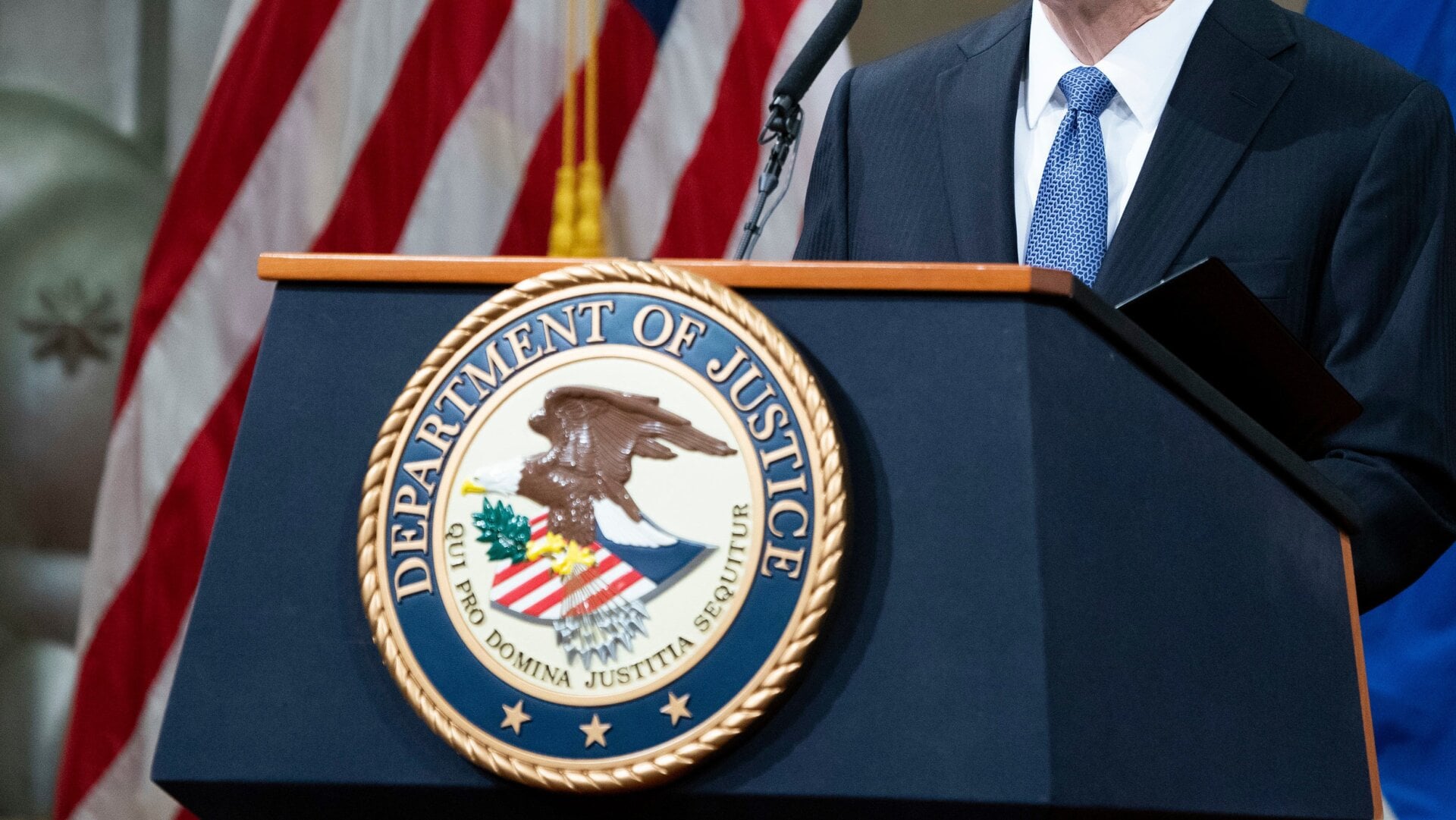 The seal of the U.S. Department of Justice as Attorney General Merrick Garland addresses staff on his first day in March 2021.