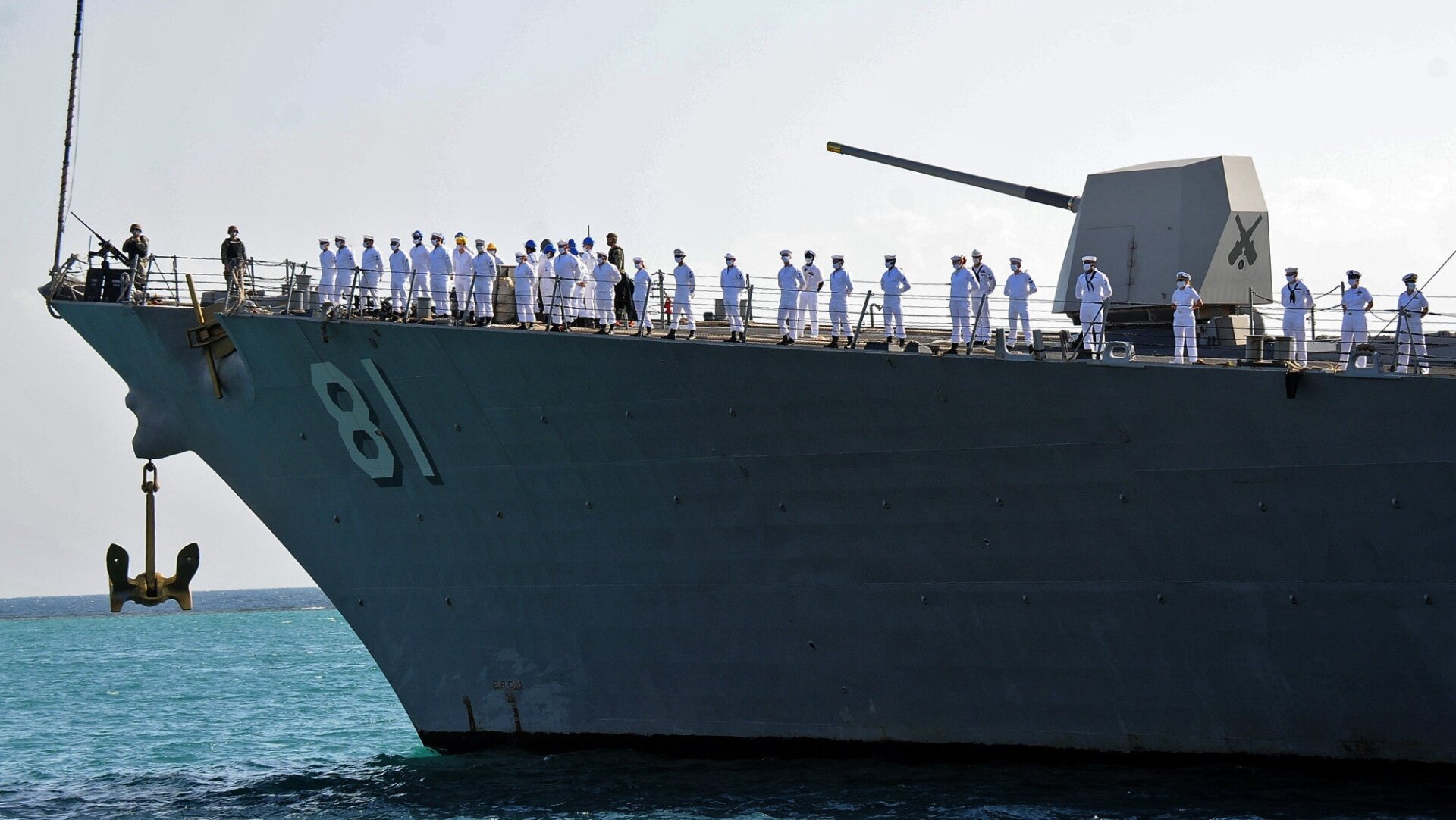 US sailors look on as they stand aboard the US Navy guided-missile destroyer USS Winston S. Churchill (DDG 81), part of Destroyer Squadron 2, while it anchors in Port Sudan on March 1, 2021. 