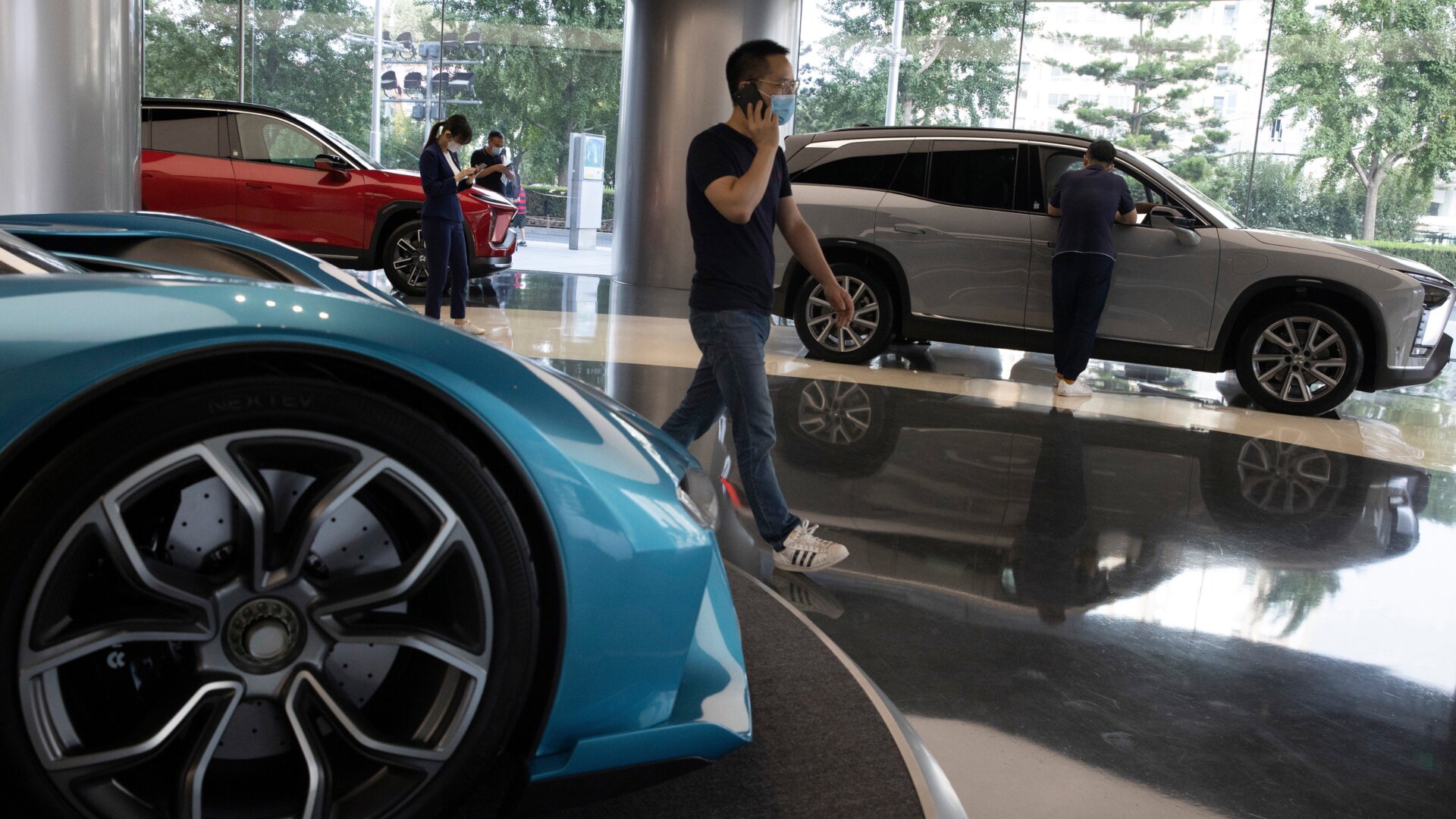 Visitors look at vehicles at the NIO flagship store in Beijing on Thursday, Aug. 20, 2020.