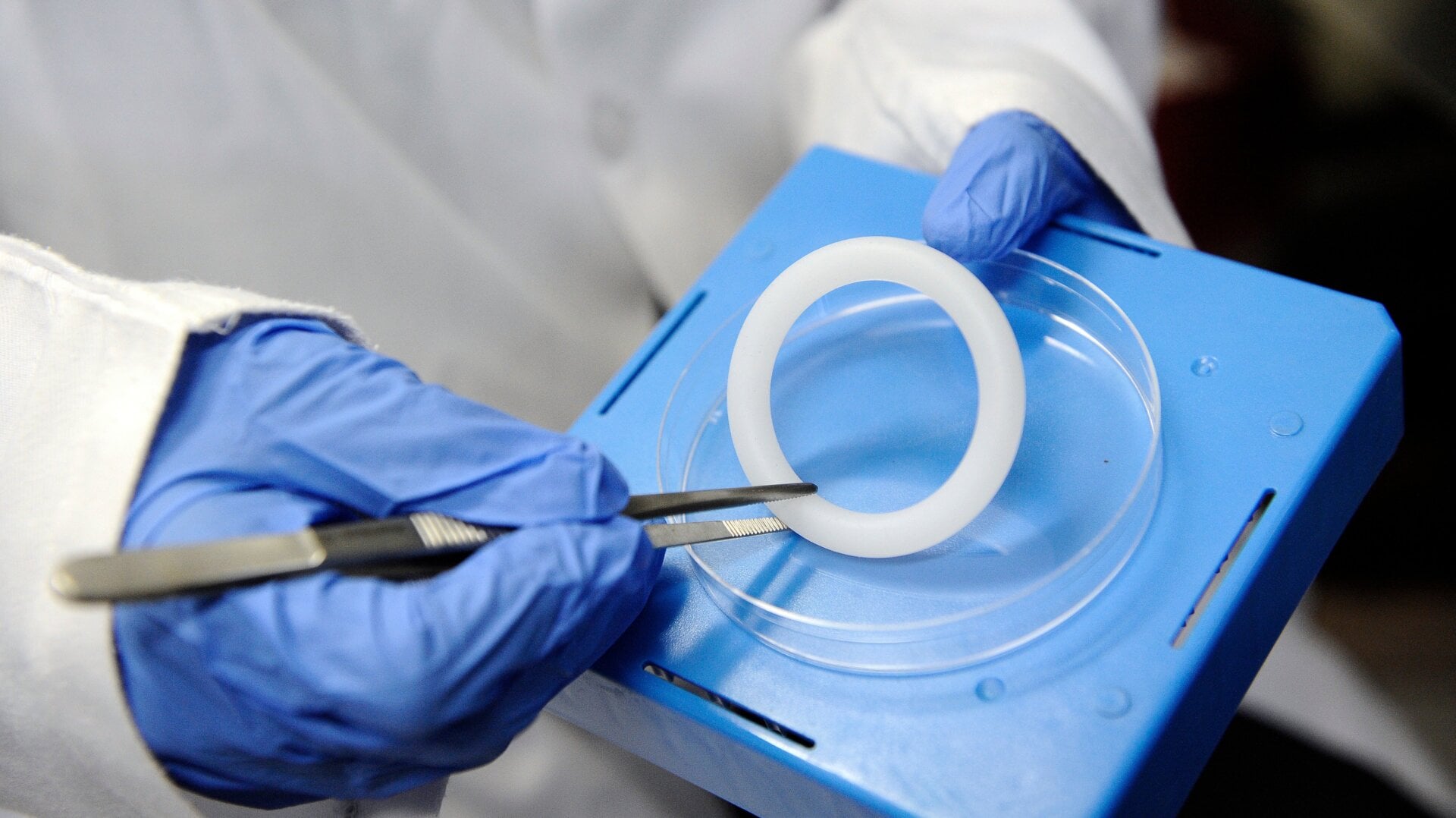A health worker at the Wits Reproductive Health and HIV Institute (WRHI) in Johannesburg, South Africa showing off a Dapivirine vaginal ring that would be used in an HIV prevention trial on July 20, 2012