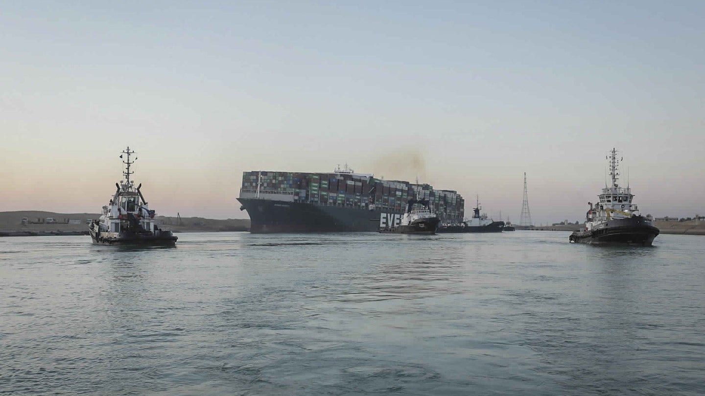 In this photo released by Suez Canal Authority, the Ever Given, a Panama-flagged cargo ship is pulled by tugboats, in the Suez Canal.
