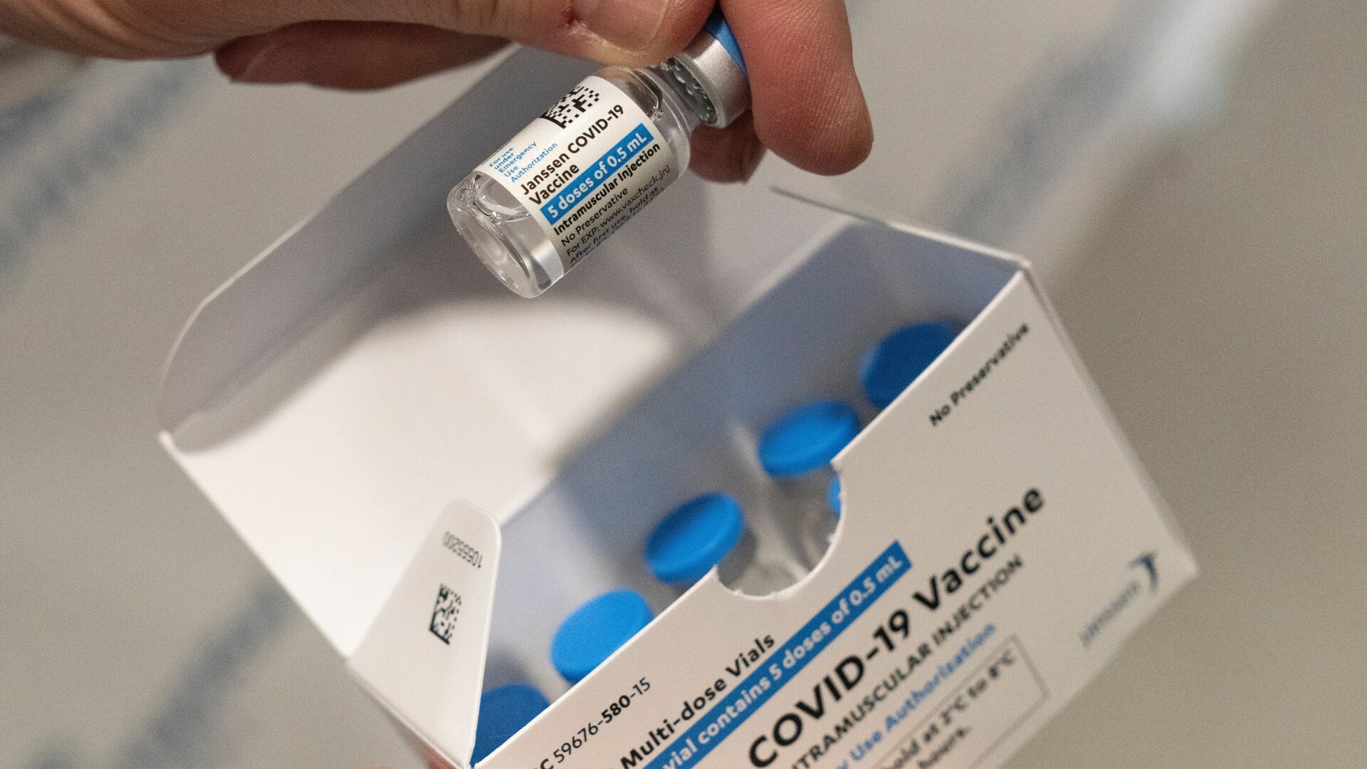 A pharmacist holds a vial of the Johnson & Johnson covid-19 vaccine at a hospital in Bay Shore, N.Y.