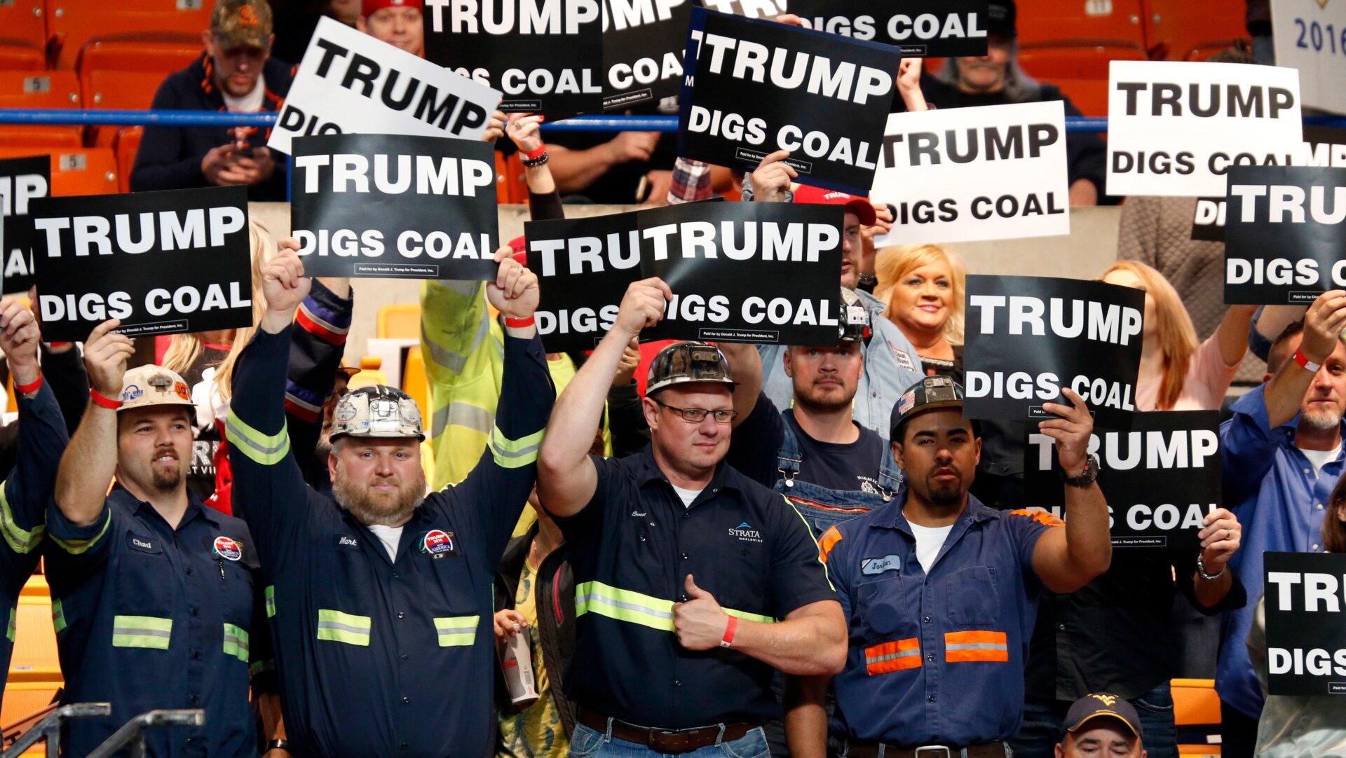 A group of coal miners wave signs for Donald Trump.