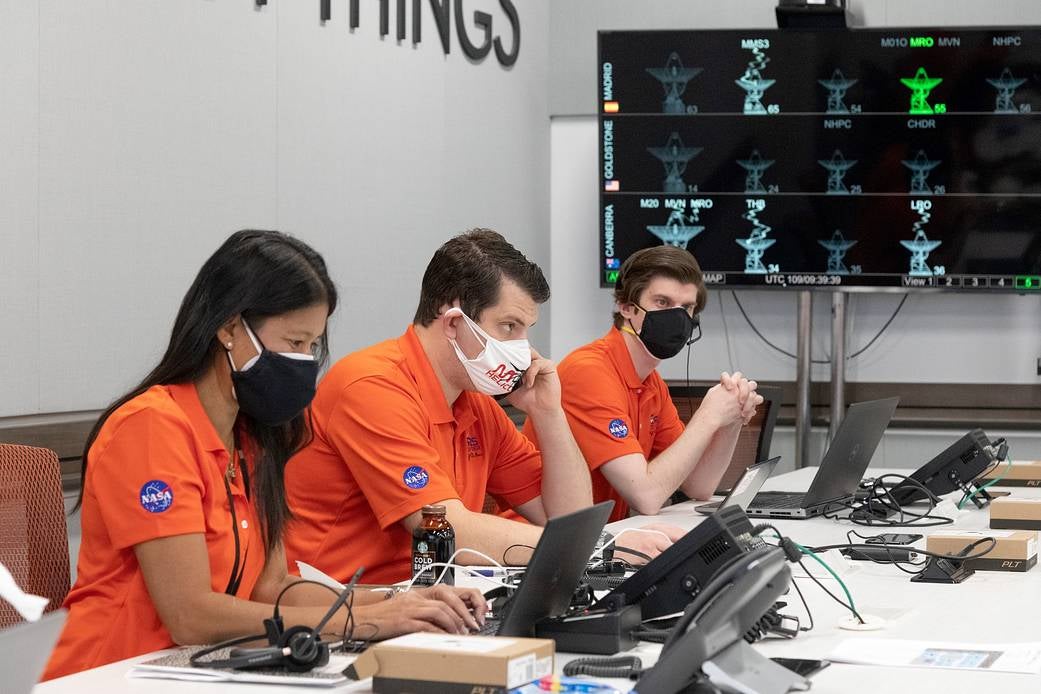 Aung (left) and other members of the Ingenuity team awaited data from Mars early this morning.