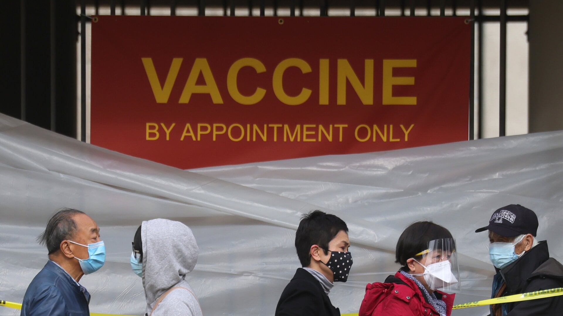 People stand in line to receive a covid-19 vaccine at a vaccination site at Lincoln Park on January 28, 2021 in Los Angeles, California.