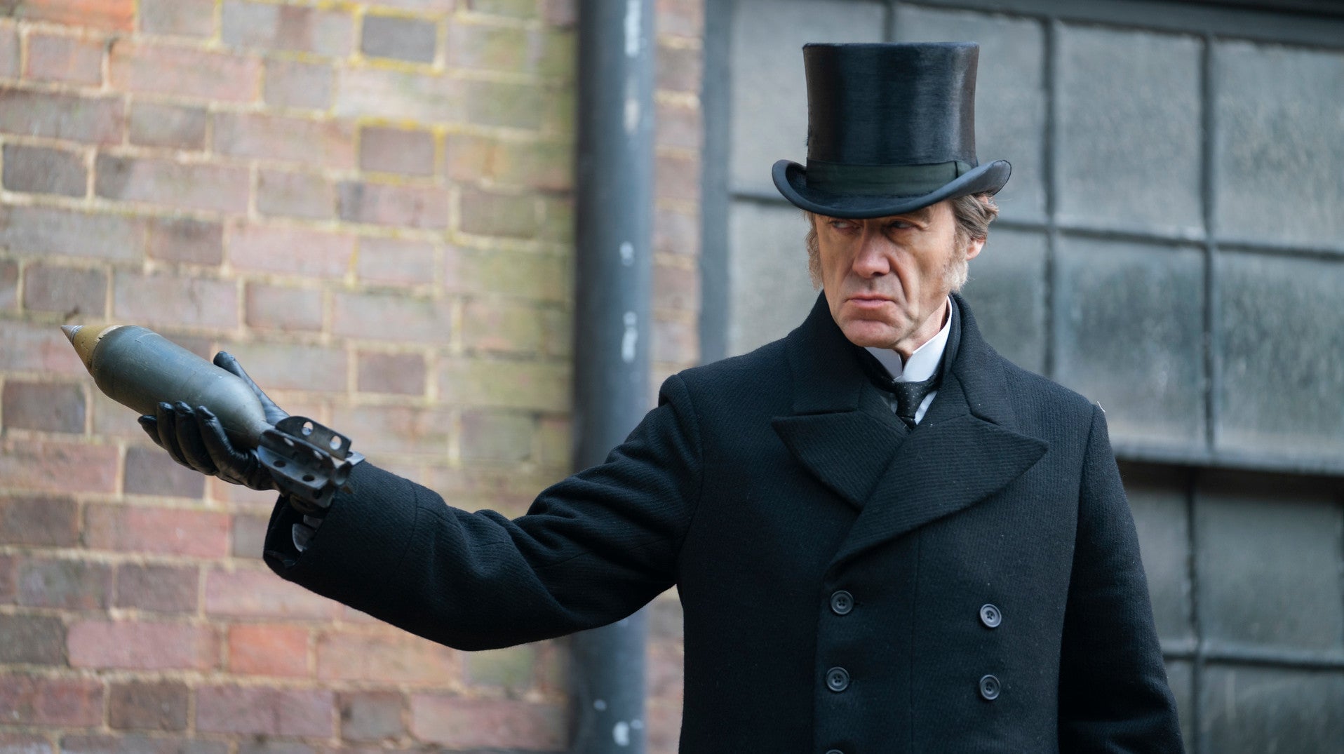Pip Torrens as Lord Massen, casually holding a bomb.