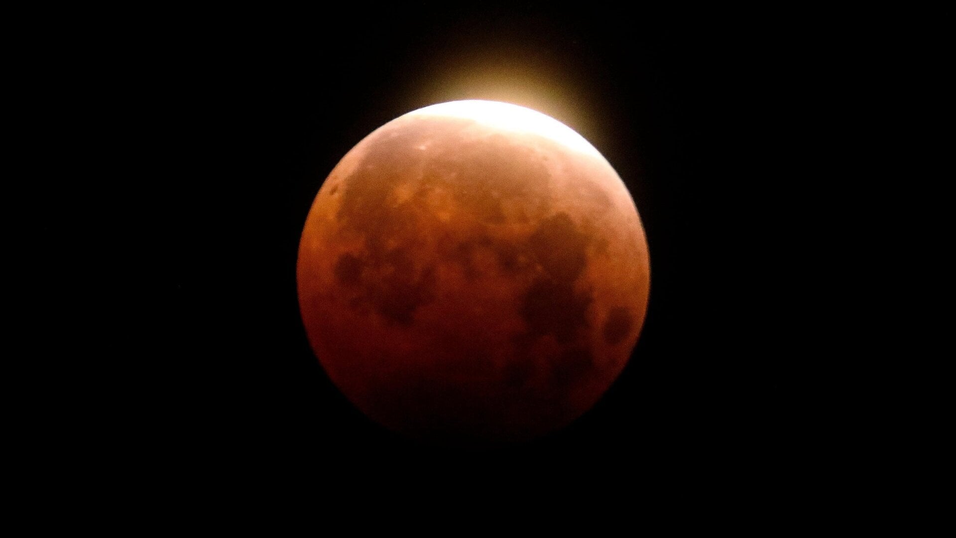 A total lunar eclipse is seen over Santa Monica Beach in Santa Monica,  Calif., Wednesday, May 26, 2021. The first total lunar eclipse in more  than two years is coinciding with a supermoon for quite a cosmic show.