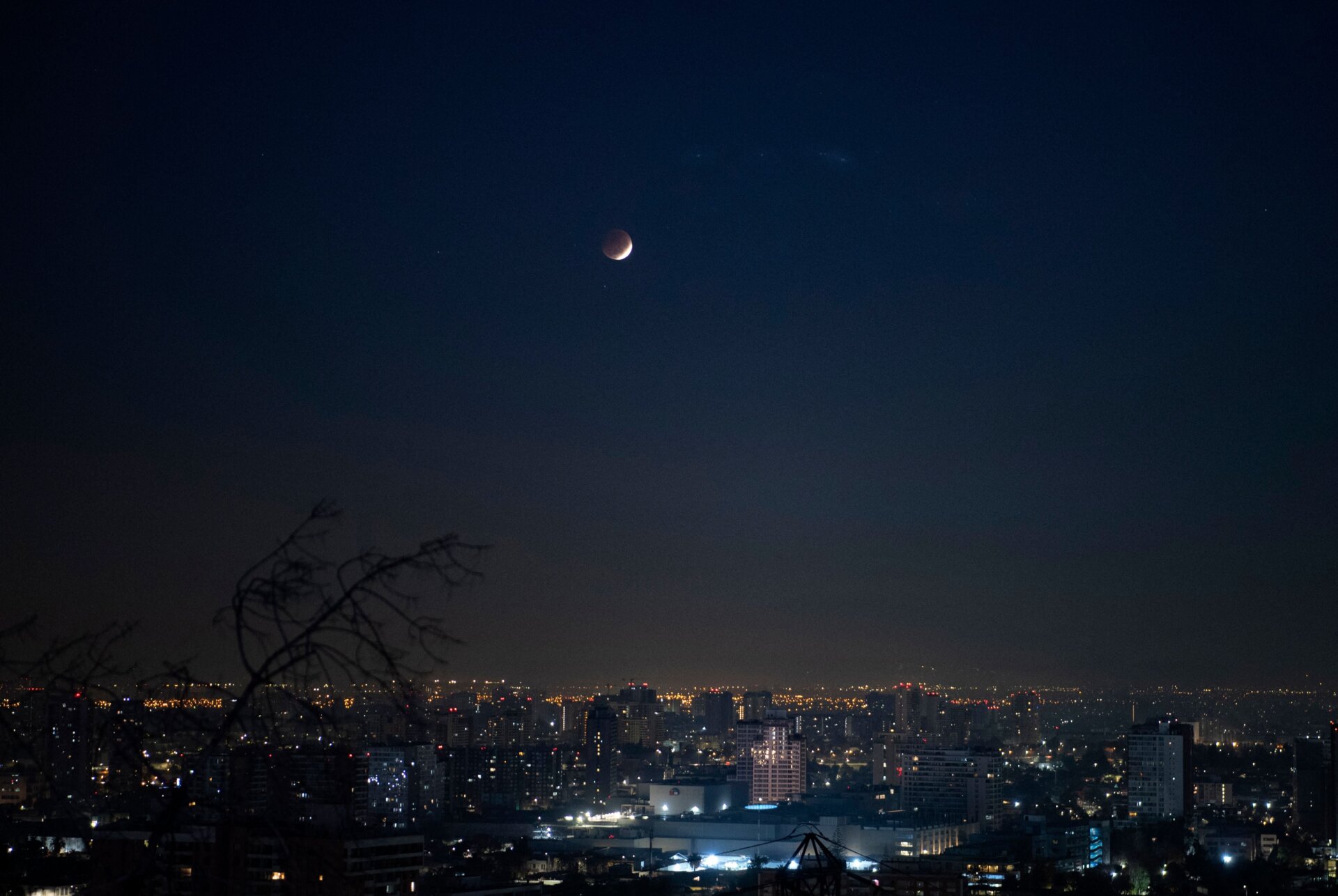 Picture taken during the penumbral phase of a total eclipse of the moon, seen from Santiago, on May 26, 2021. - A penumbra lunar eclipse appears when the moon enters the penumbra of the earth. 