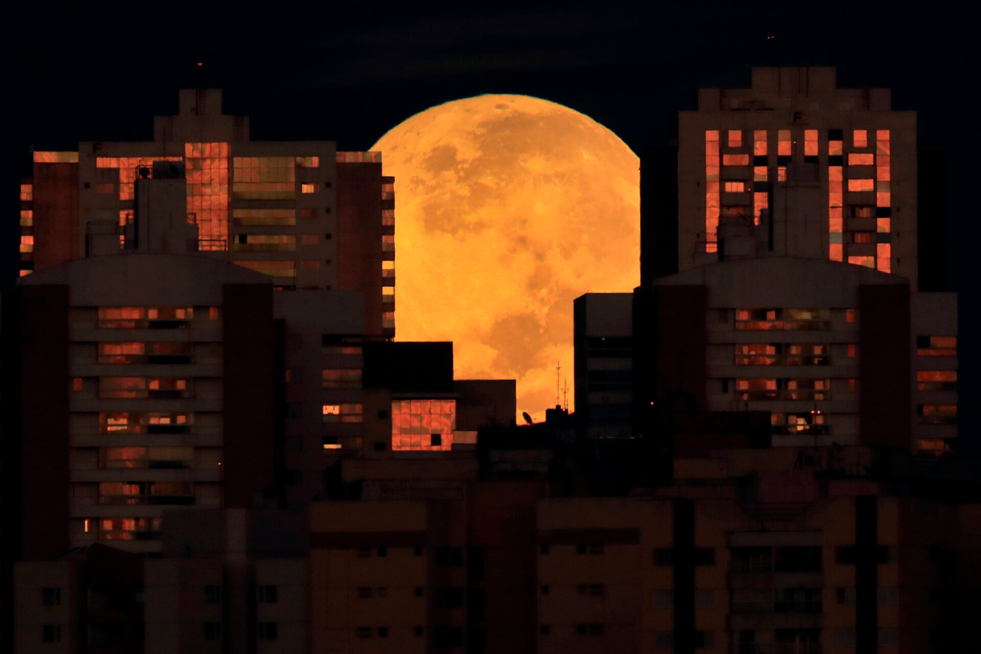 The moon is partiasanlly covered by buildings in Brasilia, Brazil, at the  start of a total lunar eclipse early Wednesday, May 26, 2021.
