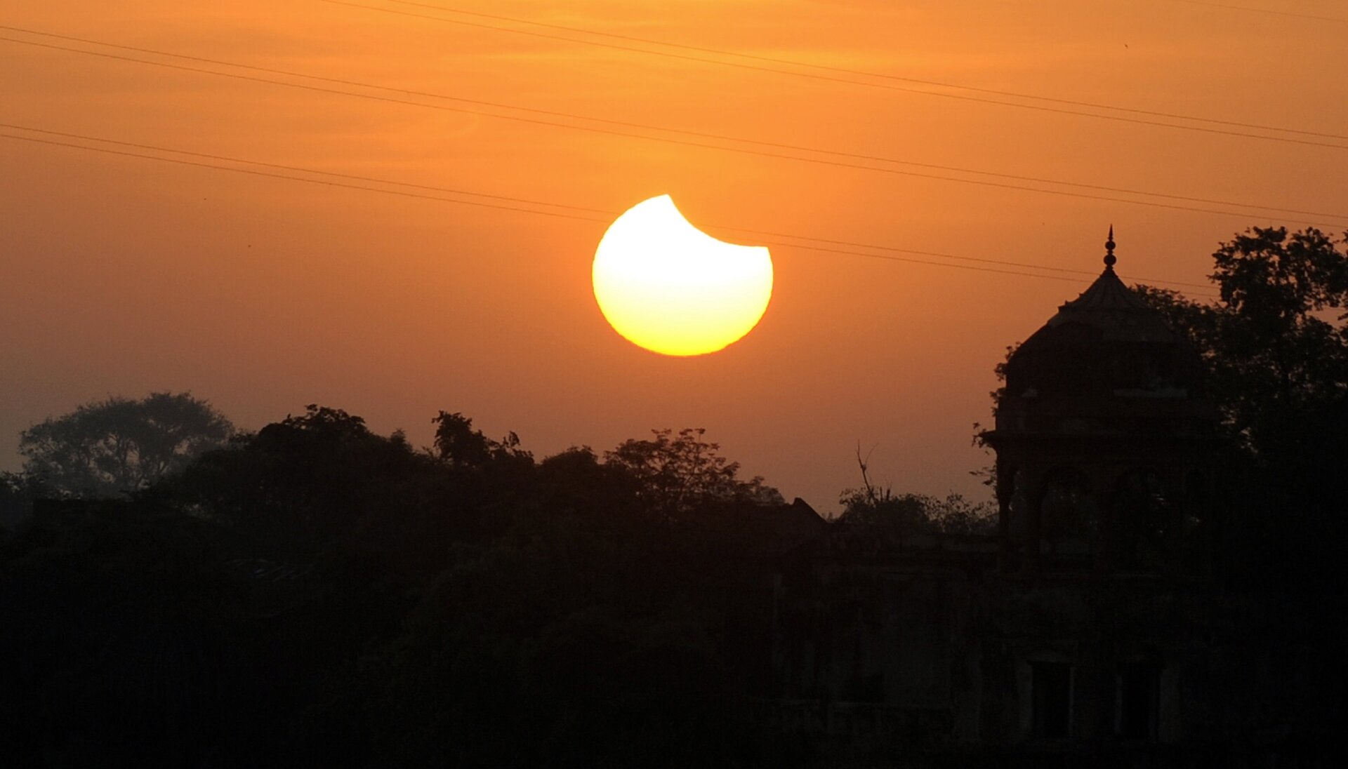 A partial solar eclipse sets over a minaret in Agra, India on July 22, 2009.