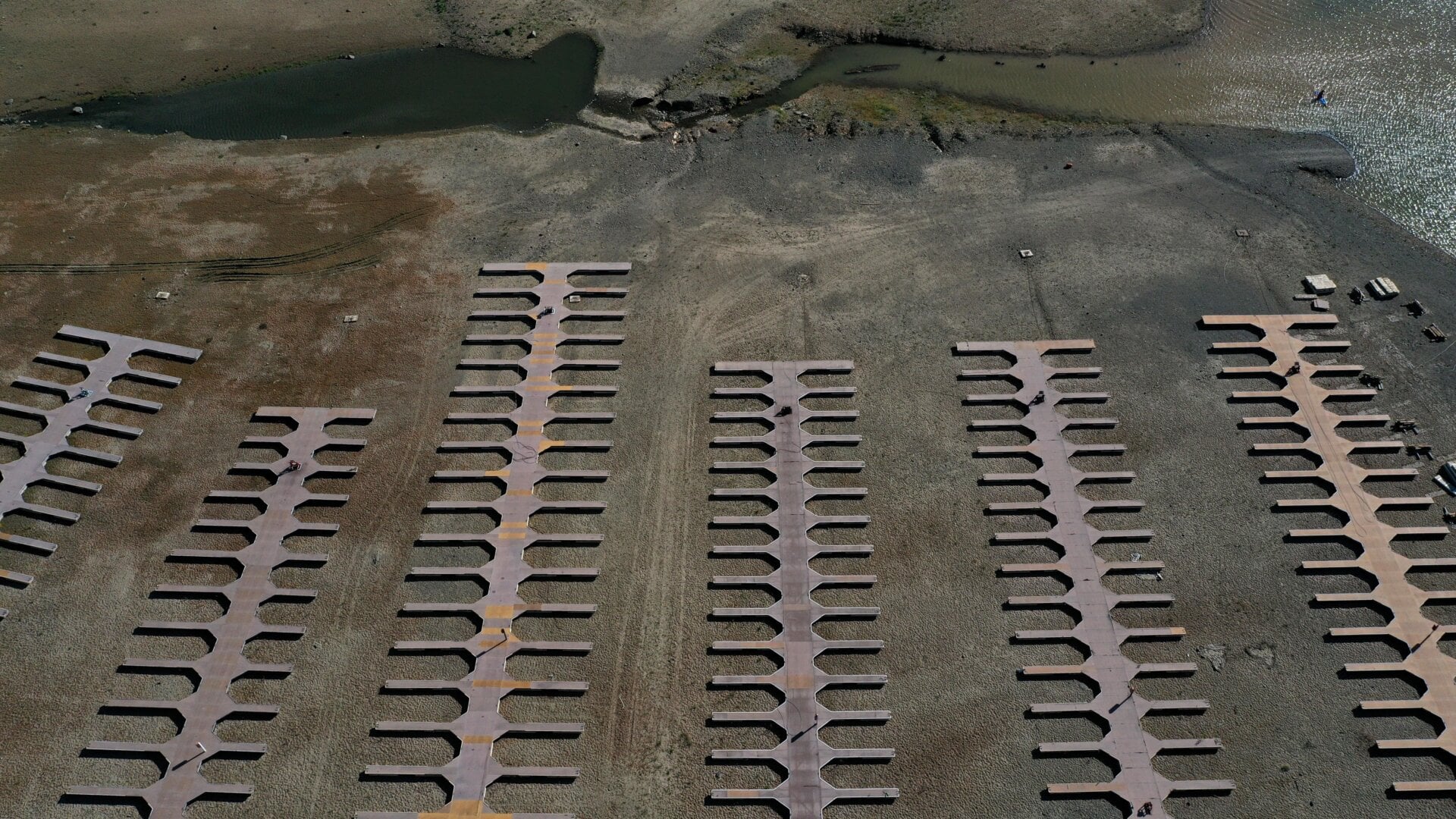 In an aerial view, boat docks at the Browns Ravine Cove sit on dry earth at Folsom Lake on May 10, 2021 in El Dorado Hills, California.