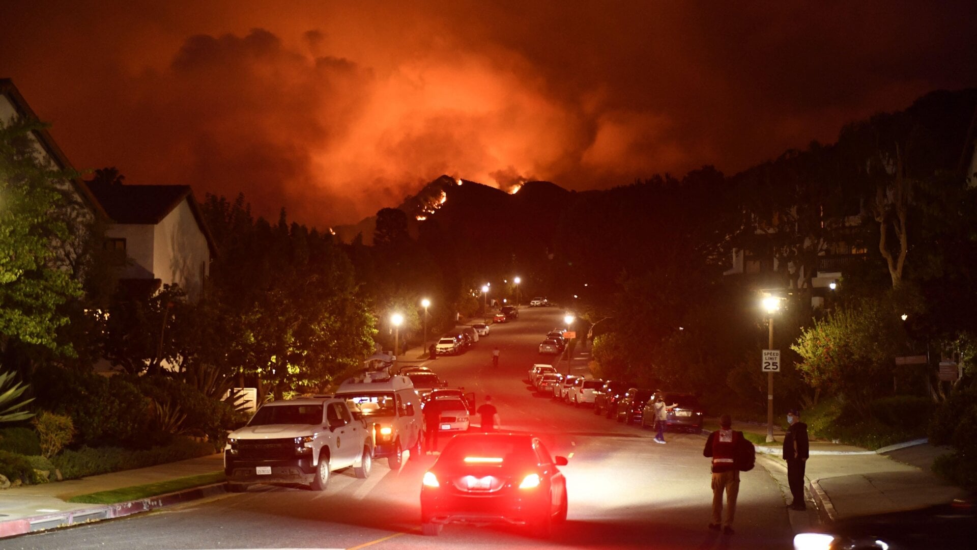 Flames from the Palisades Fire glow in the distance in Topanga, northwest of Los Angeles, May 15, 2021.