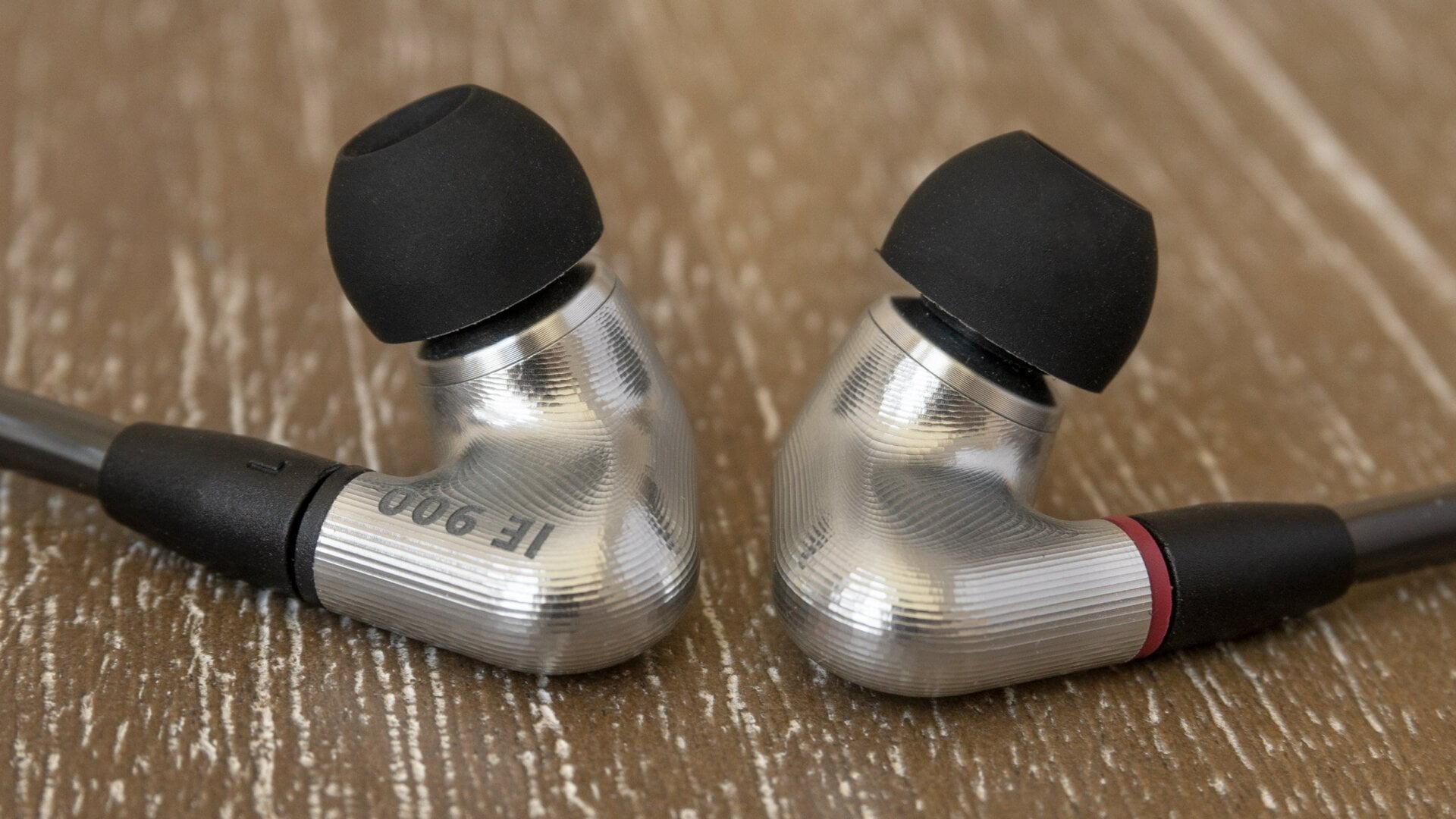 The earbuds use flexible wires that run up and over the ears to provide a more secure fit, but I’m not sure I’d ever be comfortable going for a run while wearing them.